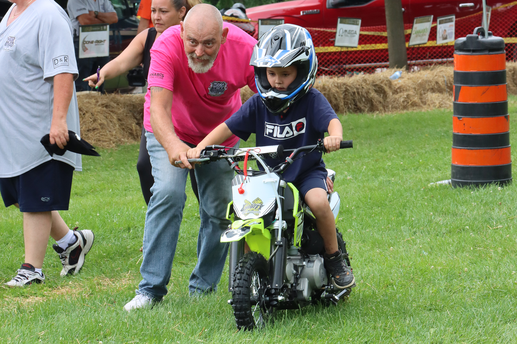 A youngster gets help on his bike during the 2023 Junior Bike Rodeo.