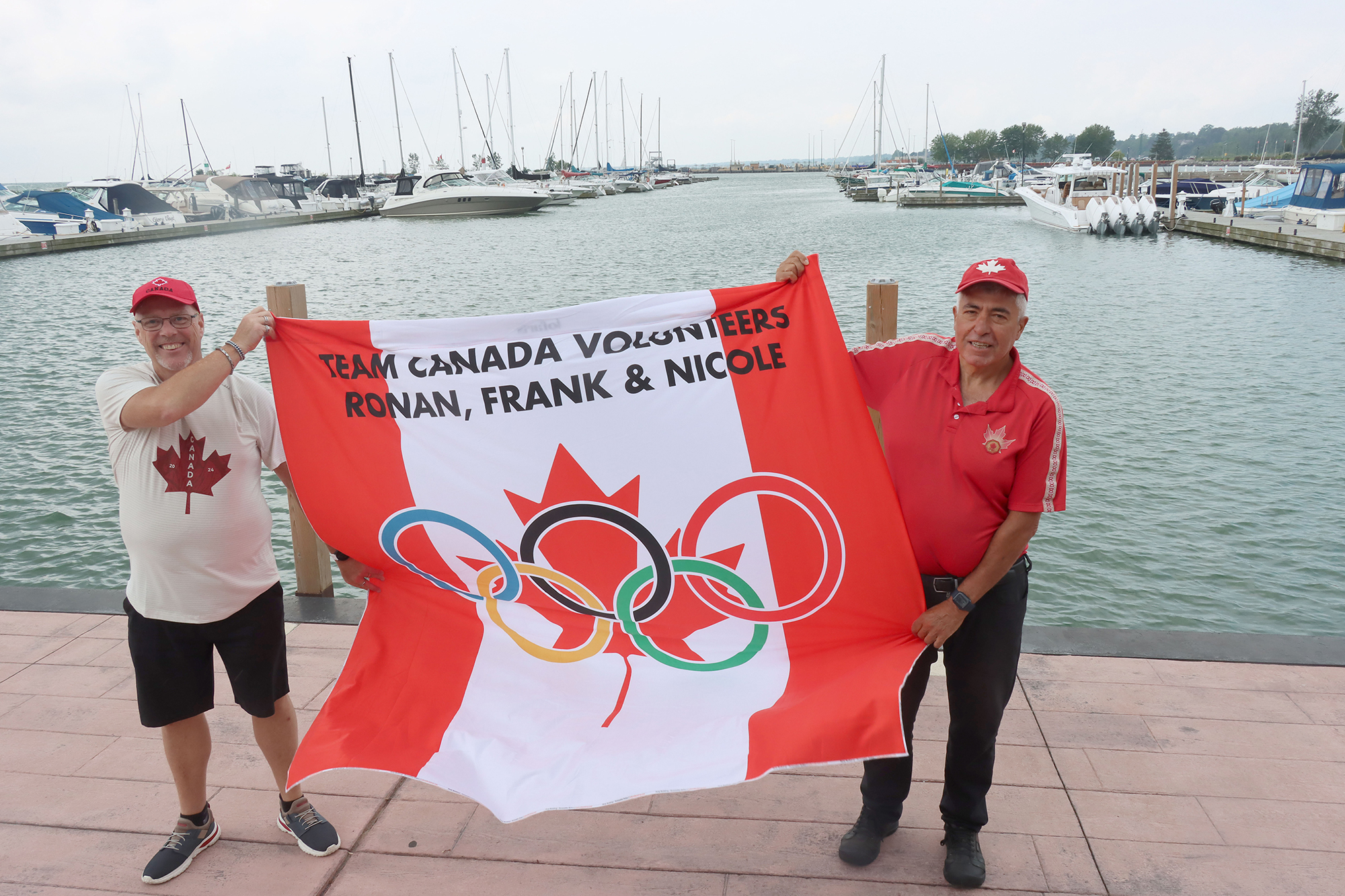 Ronan and Frank holding up a banner they had created for their trip to the Paris Olympics.