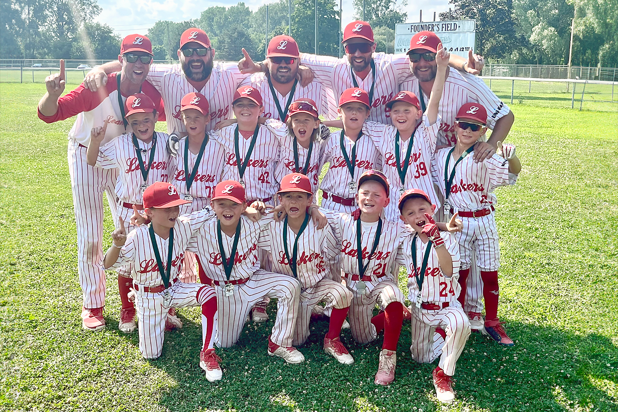 8U Leamington Lakers champions showing their medal in a group picture.