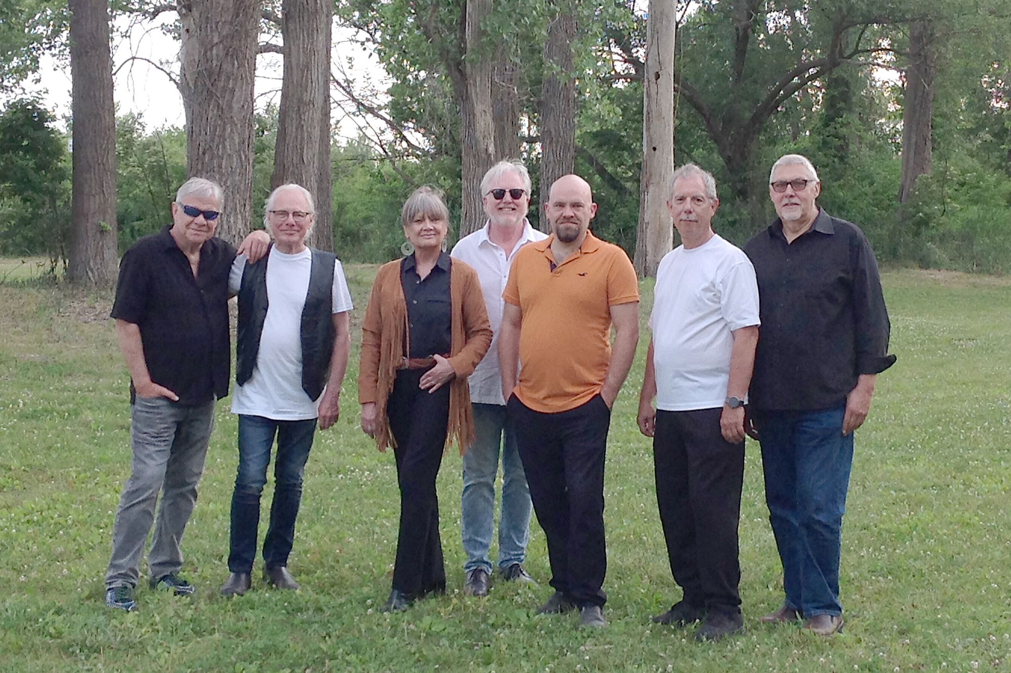 Mary Newland and The Blue Bayou Band standing outside together.