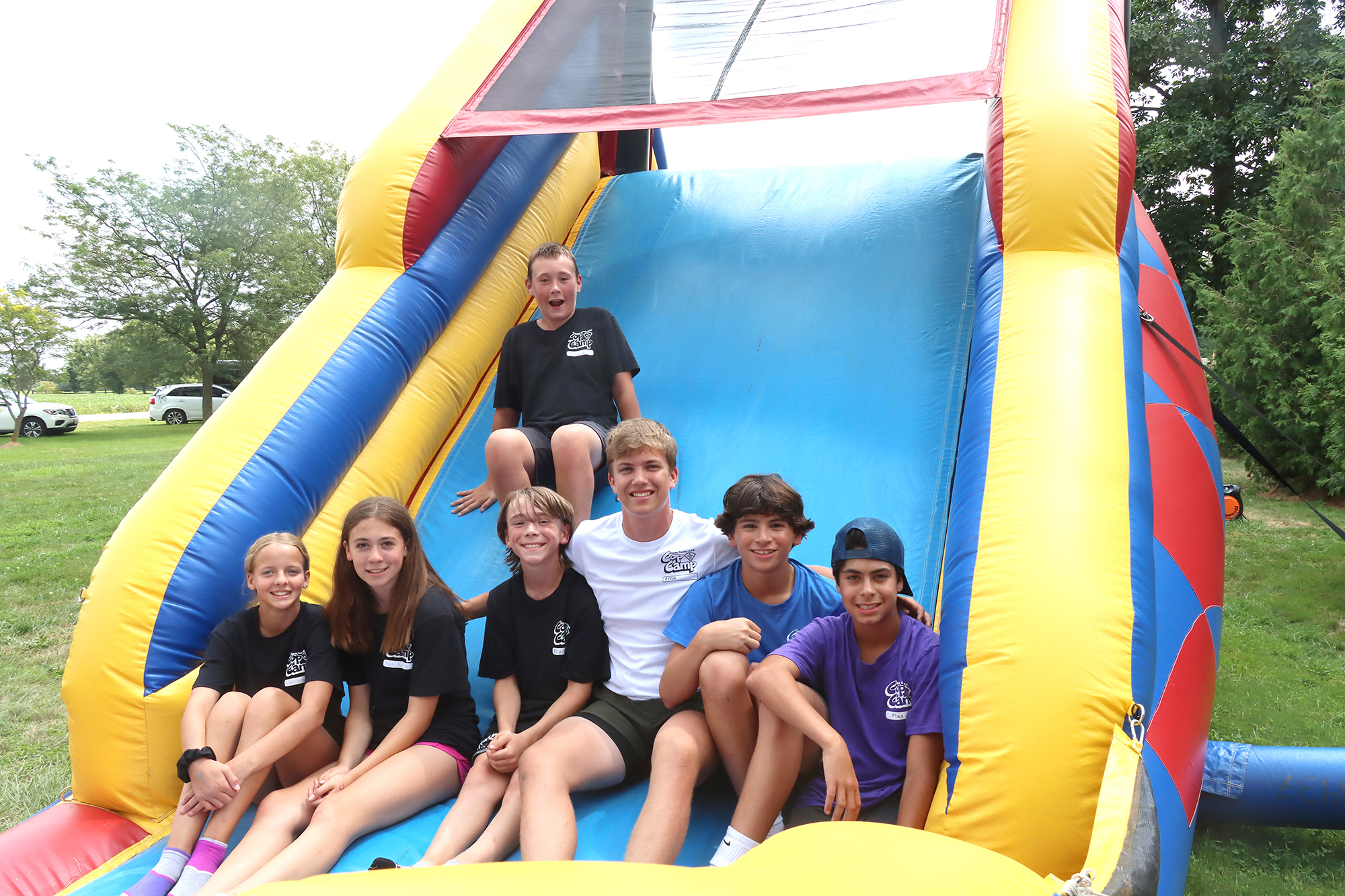 Students and their junior counsellor having a blast on the inflatable obstacle course.