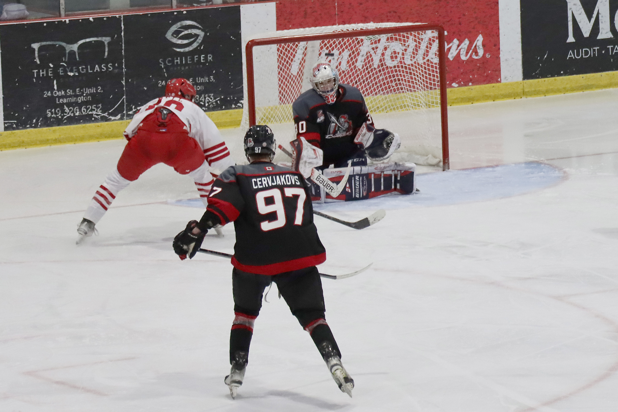 Flyers centre Cade Bell shoots the puck above the head of goalie Hayden Sabourin.