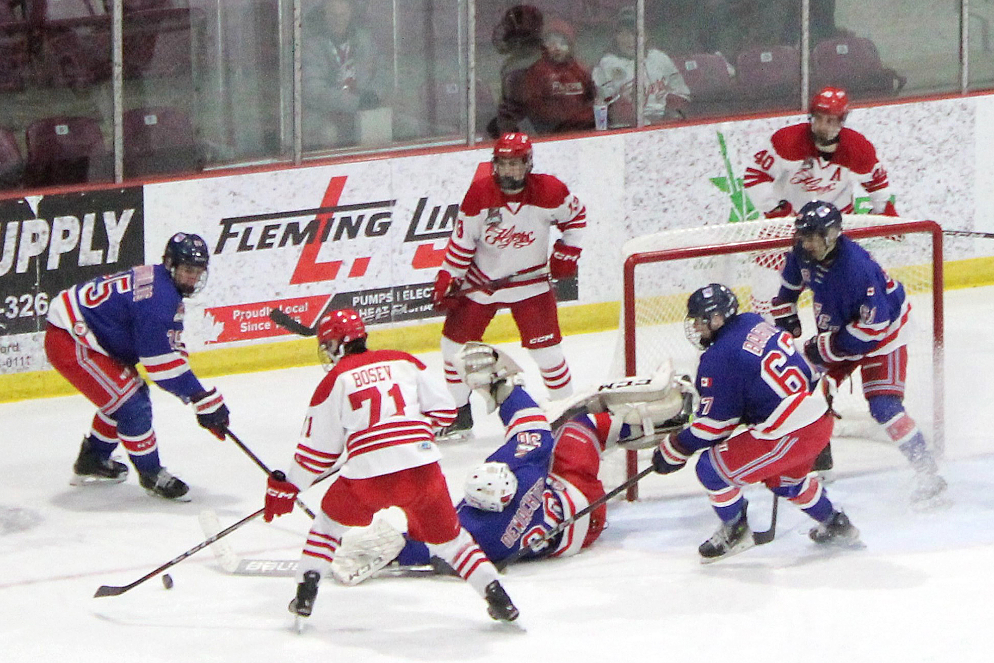 Flyer captain Adrian Bosev takes a pass from Griffin Grundner from behind net.