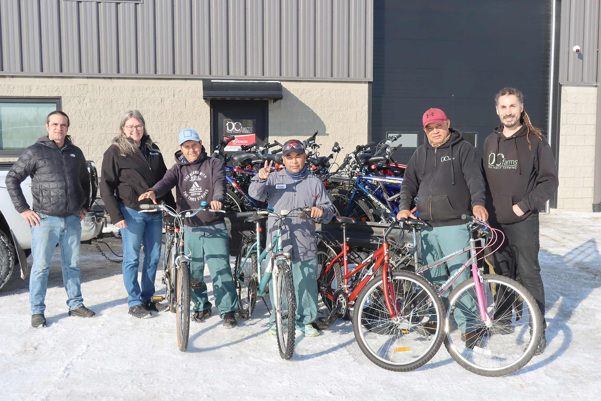 Ron Drouillard (Bike Kitchen), Kim DeYong (Kingsville Community Centrre, workers Gonzalo, Paulino and Wibi, with owner of DC Farms, Michael Del Ciancio displaying the new bikes.