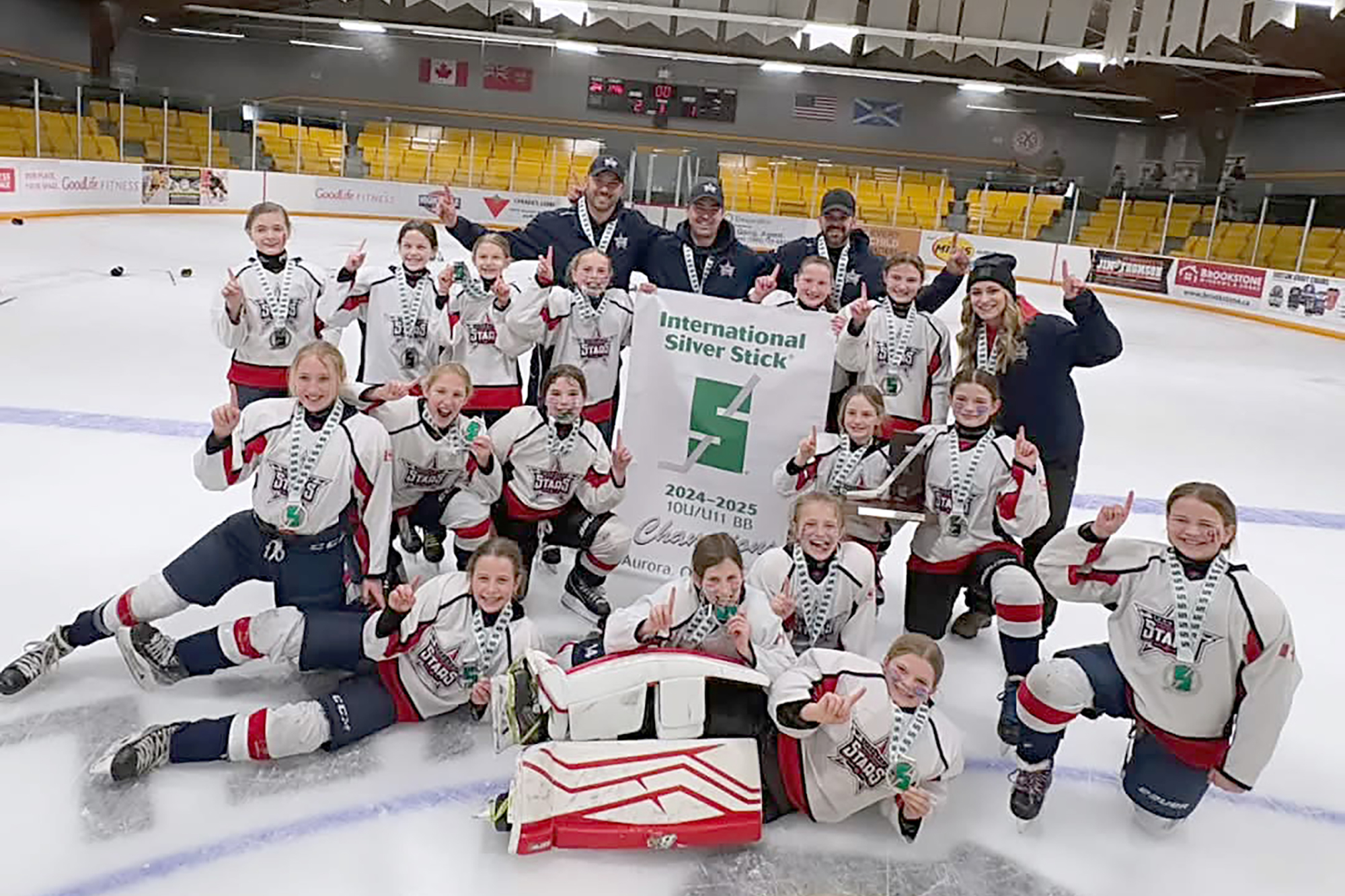 The 2024-25 International Silver Stick Champs on the ice for a team photo.