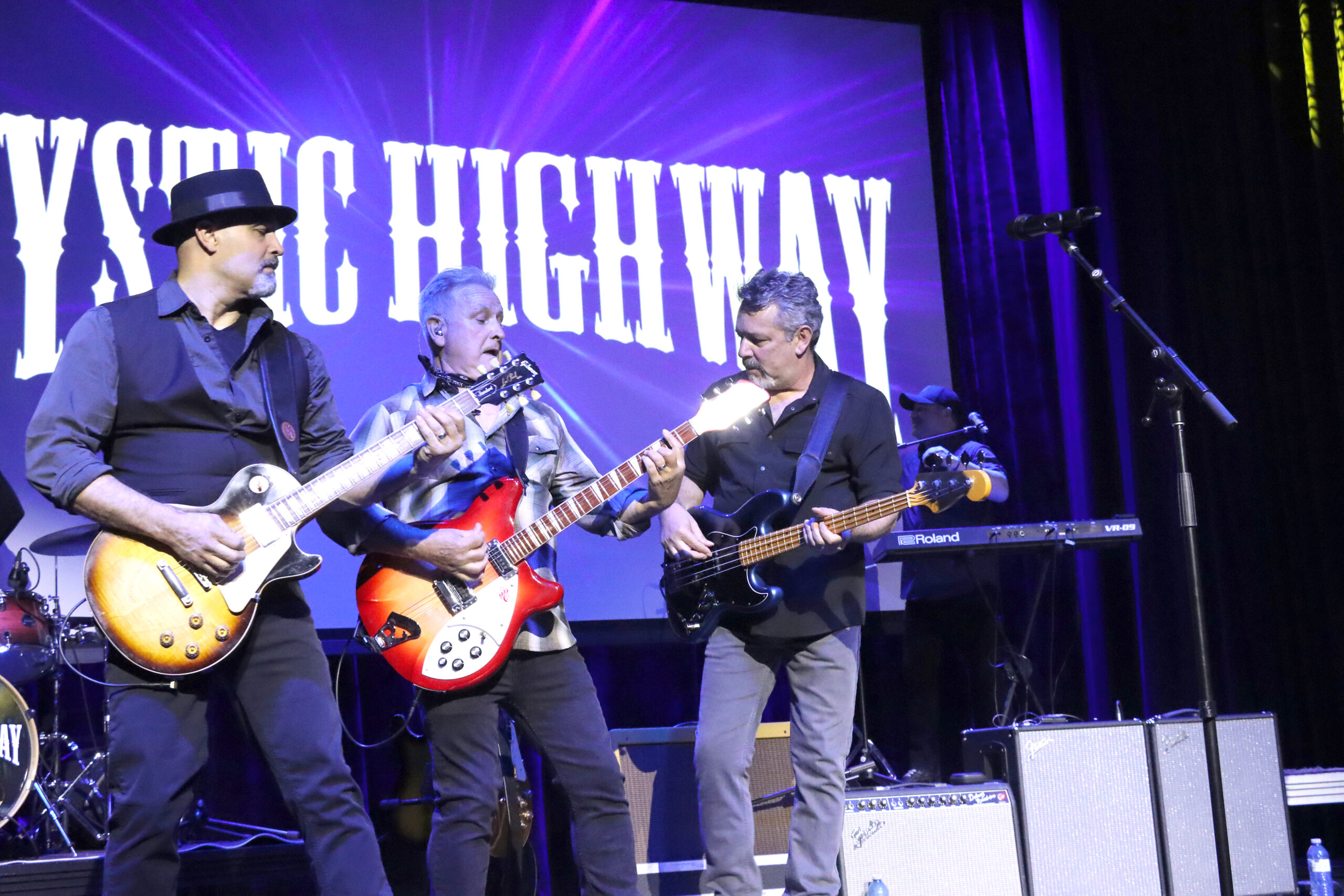 Mystic Highway frontman Gil Gaidola (middle) powers through a CCR song on his sunburst red Rickenbacker, flanked by bandmates Nilton Medeiros, left, and Paul Ferreira. Mystic Highway played The Bank Theatre on Saturday, March 21 to a large, appreciative crowd.