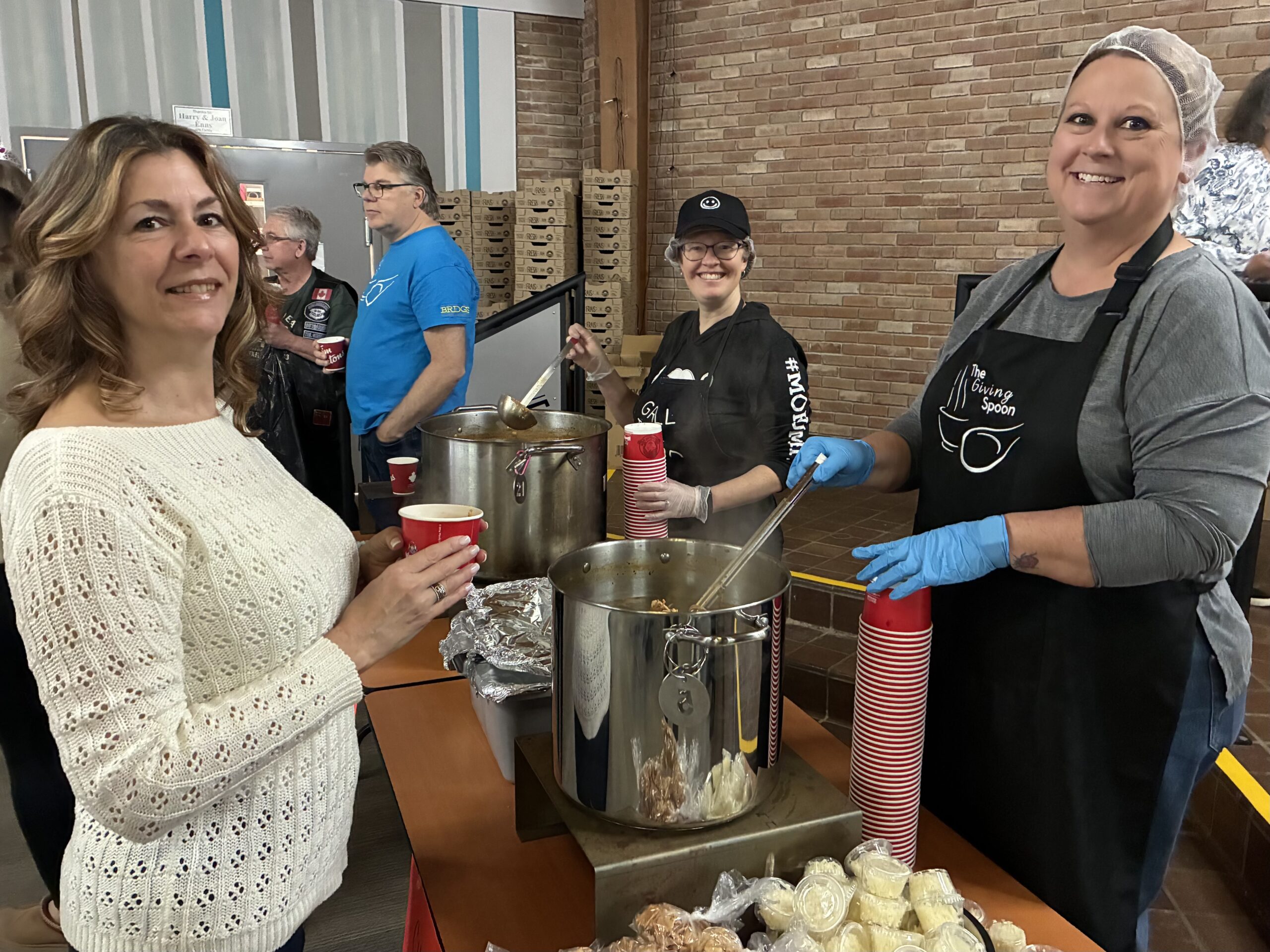 Pictured is Shelley Ingratta in line for her first of three soups for the day. On the right is longtime Bridge volunteer Colleen Quinlan ladling some delicious chicken taco soup for Shelley.