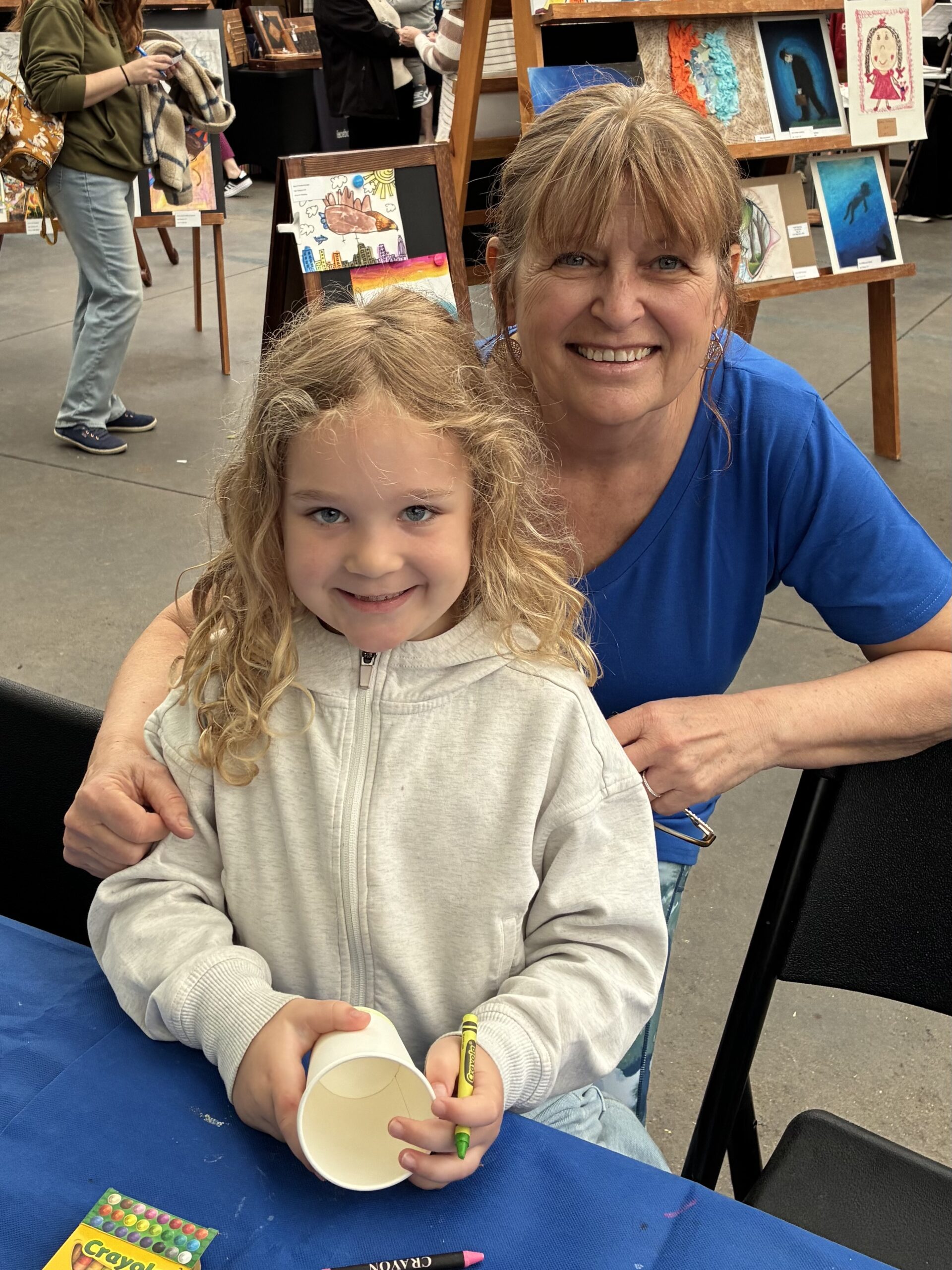 Six-year-old Audrey Epp comes from a long line of artists and is pictured here with her grandma, artist/author Joan Epp. Audrey was working on a piece that incorporated tulips in a spring garden.