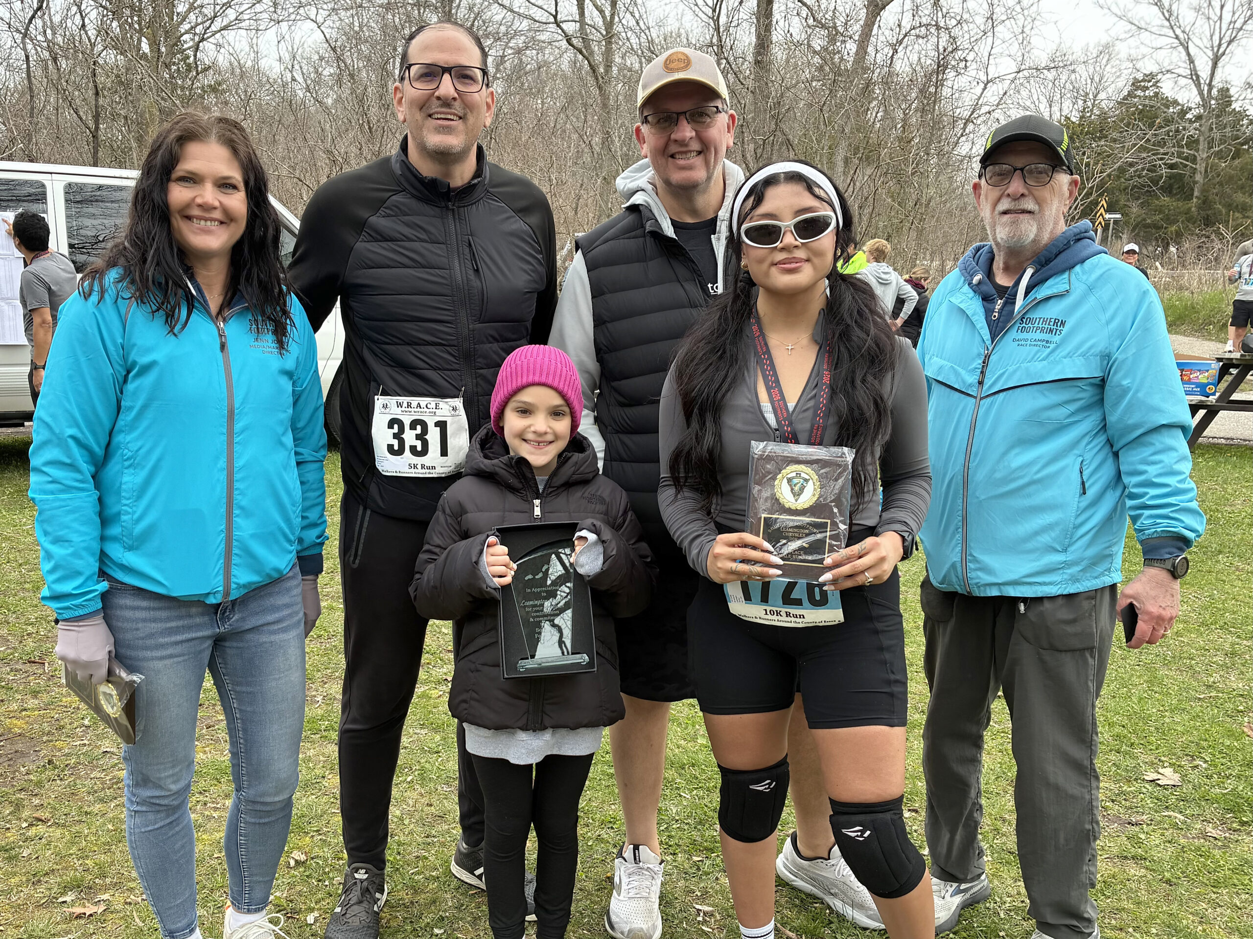 Pictured in the sunglasses is 10K women’s champ Liz Coxaj, along with, from the left, Jenn Johns, 10K sponsor from Leamington Chrysler Val Mascaro, Lucy Mascaro, Leamington Chrysler’s Tim Vida and Dave Campbell.