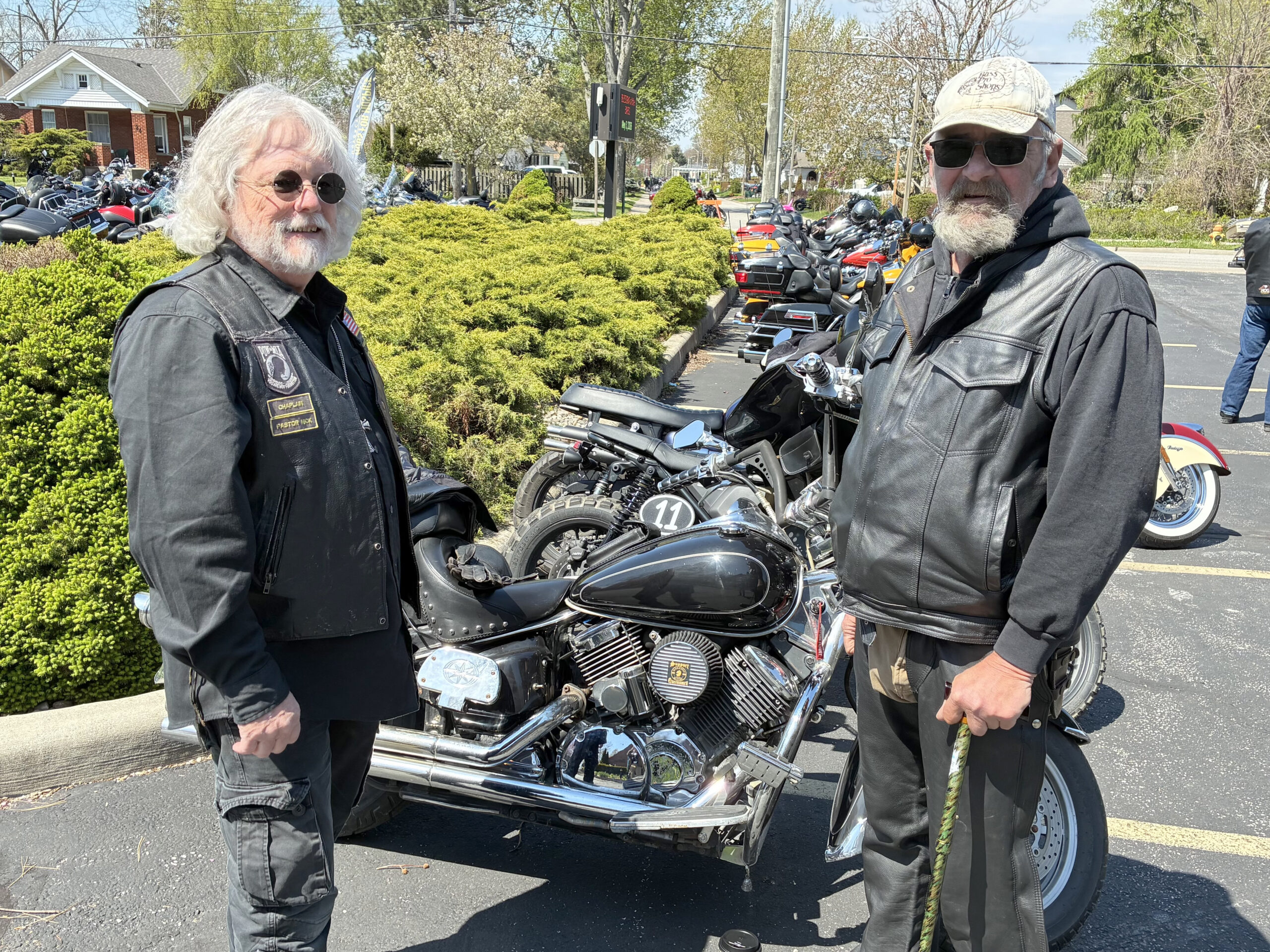Arizona pastor Nick Wirtz made his way out to the crowd after delivering the blessing for the riders. Nick is pictured with Jim DeVres (wearing a cap), providing an individual blessing for Jim and a safe riding season.