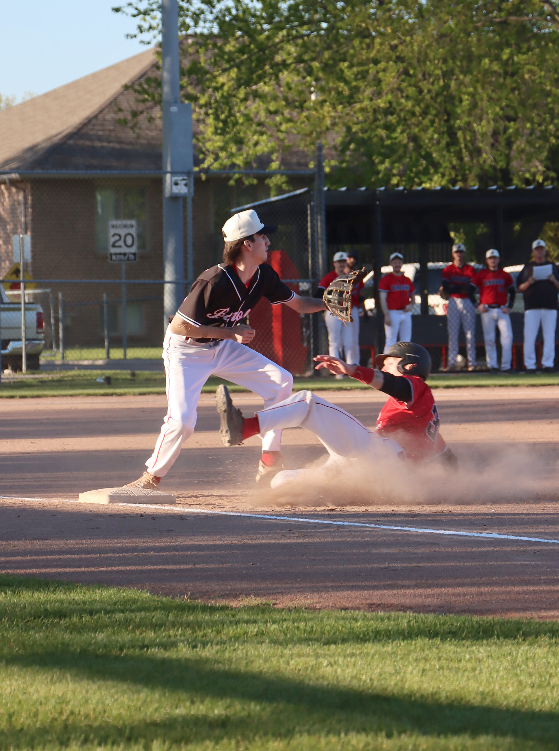 In the photo at the top, a Senior Barons runner hurries back to first base to avoid being doubled off on a fly ball catch in left field. Although he safely made it back, he was called out on an appeal. The Senior squad won the game 13-2, then the two teams met Friday, May 15 for the back end of the home-andhome openers.