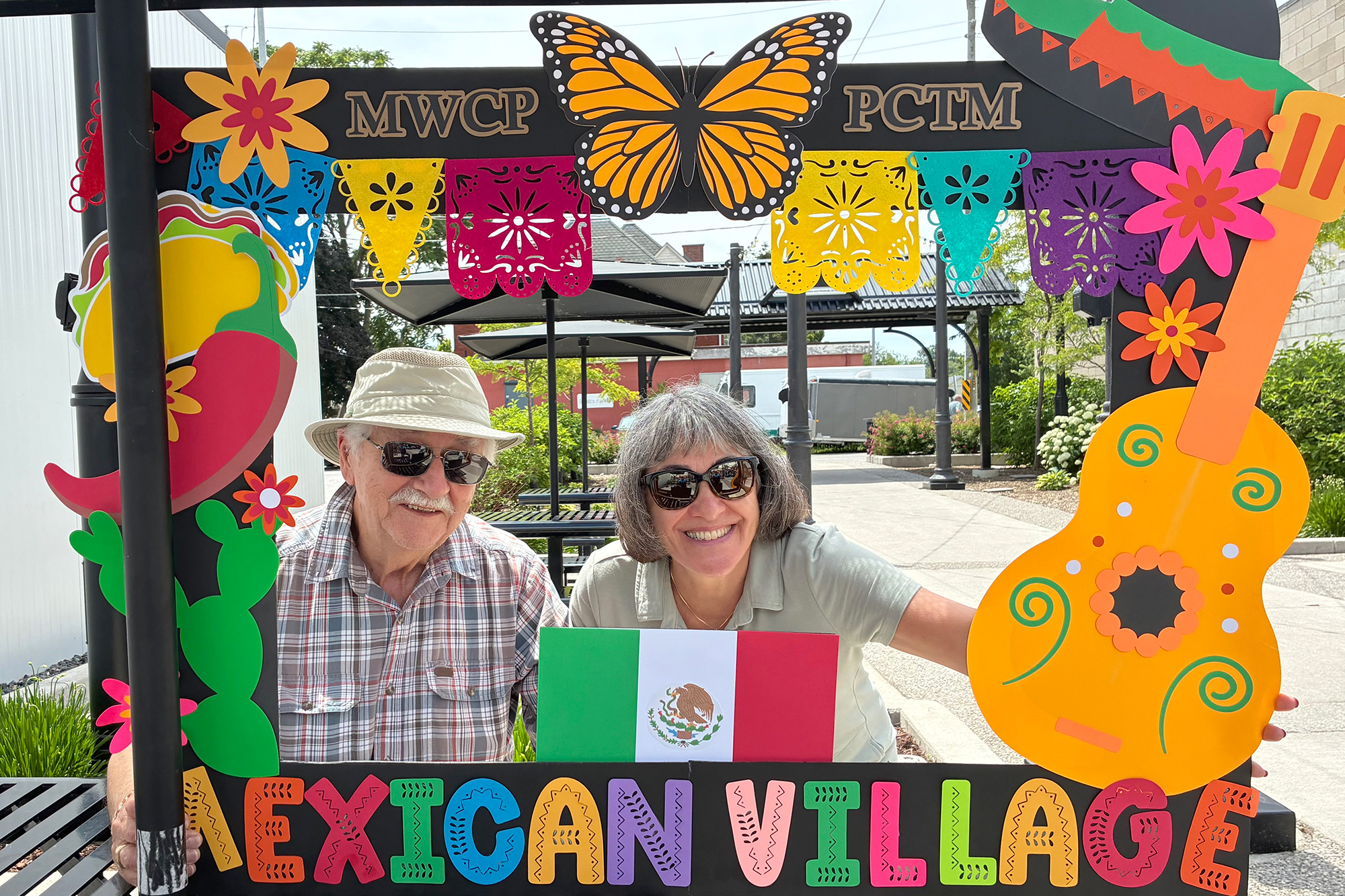 First-time visitors Roscoe Petkovic and Anna Esposito pose at the Mexican Village on Mill Street during Carousel of the Nations in Leamington.