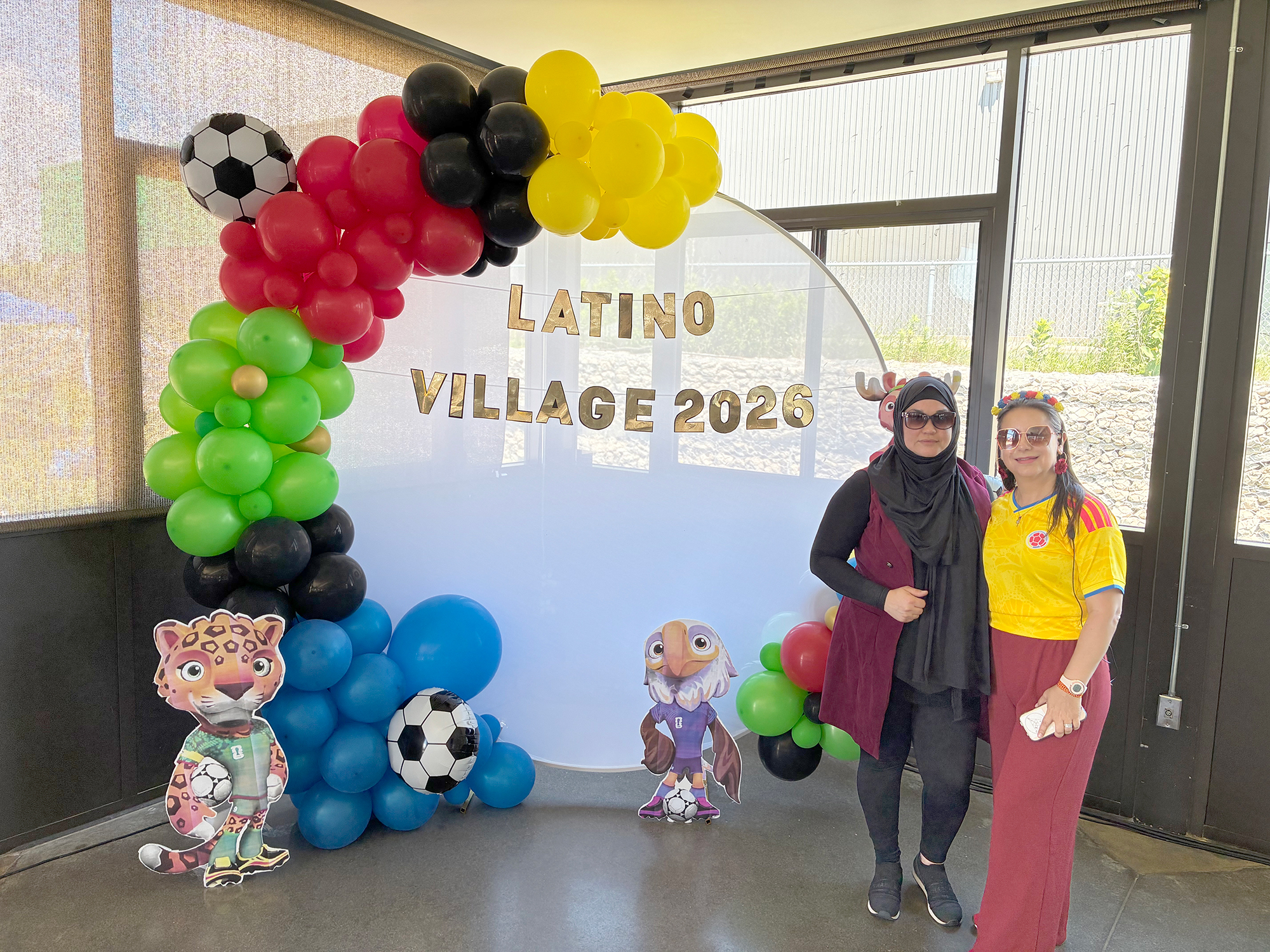 Latino Village decorator Lorainny De Darwiche and organizer Anita Vallejo stand inside the Roma Club pavilion during Carousel of the Nations in Leamington.