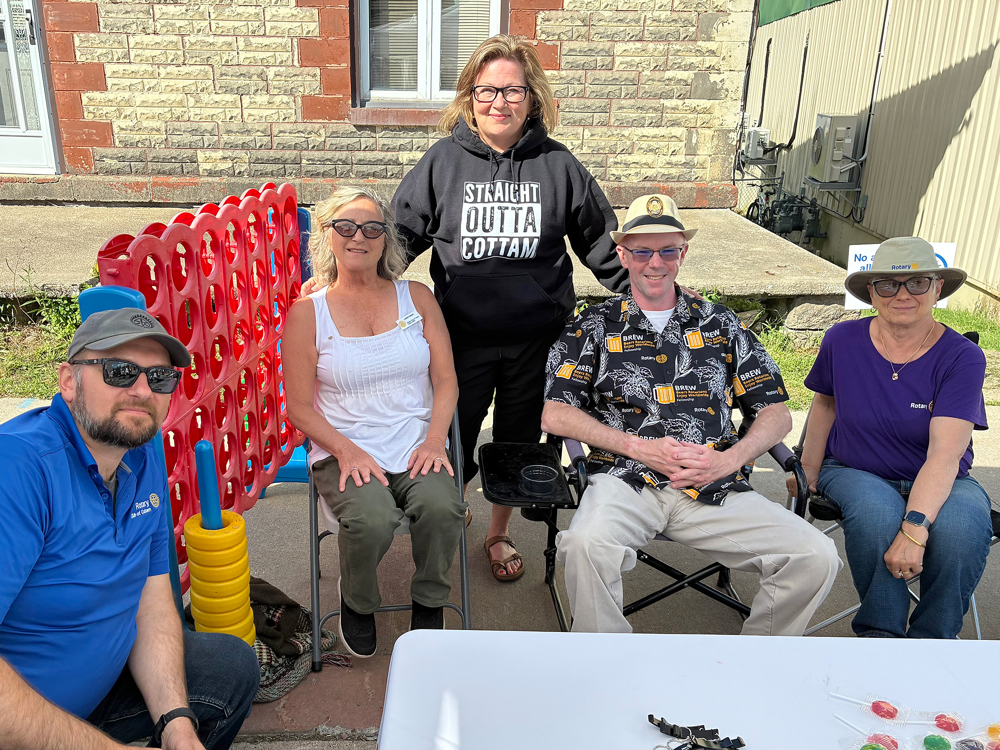 Rotary Club volunteers Mike Olajos, Janis Fabok, Maureen Macfarlane, Dan Levy and Peggy Little pose with children's giveaways at the Cottam Block Party.