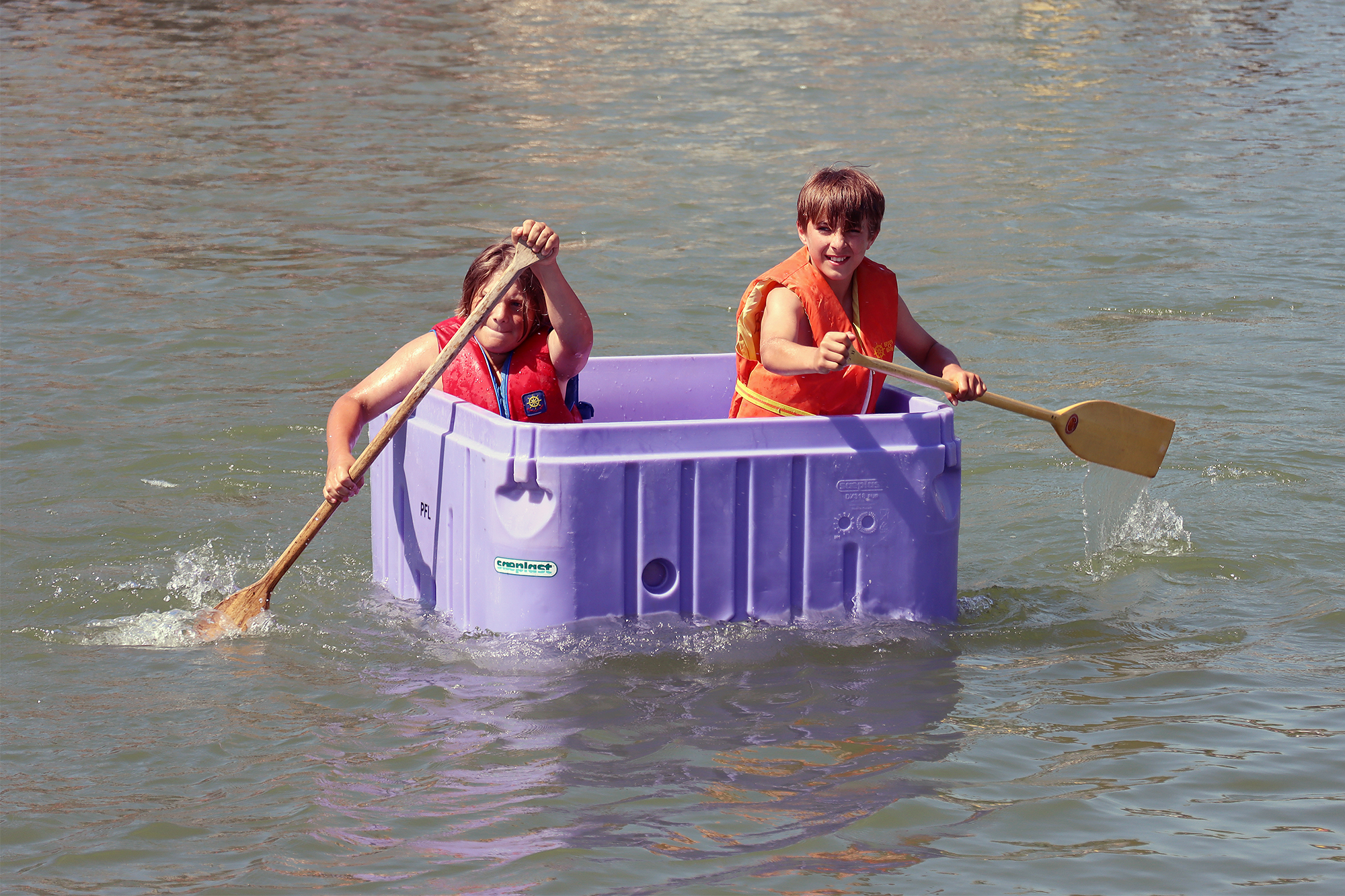 Chase Gould and Nik Sawyer compete in the fish tote race during the Wheatley Fish Festival.