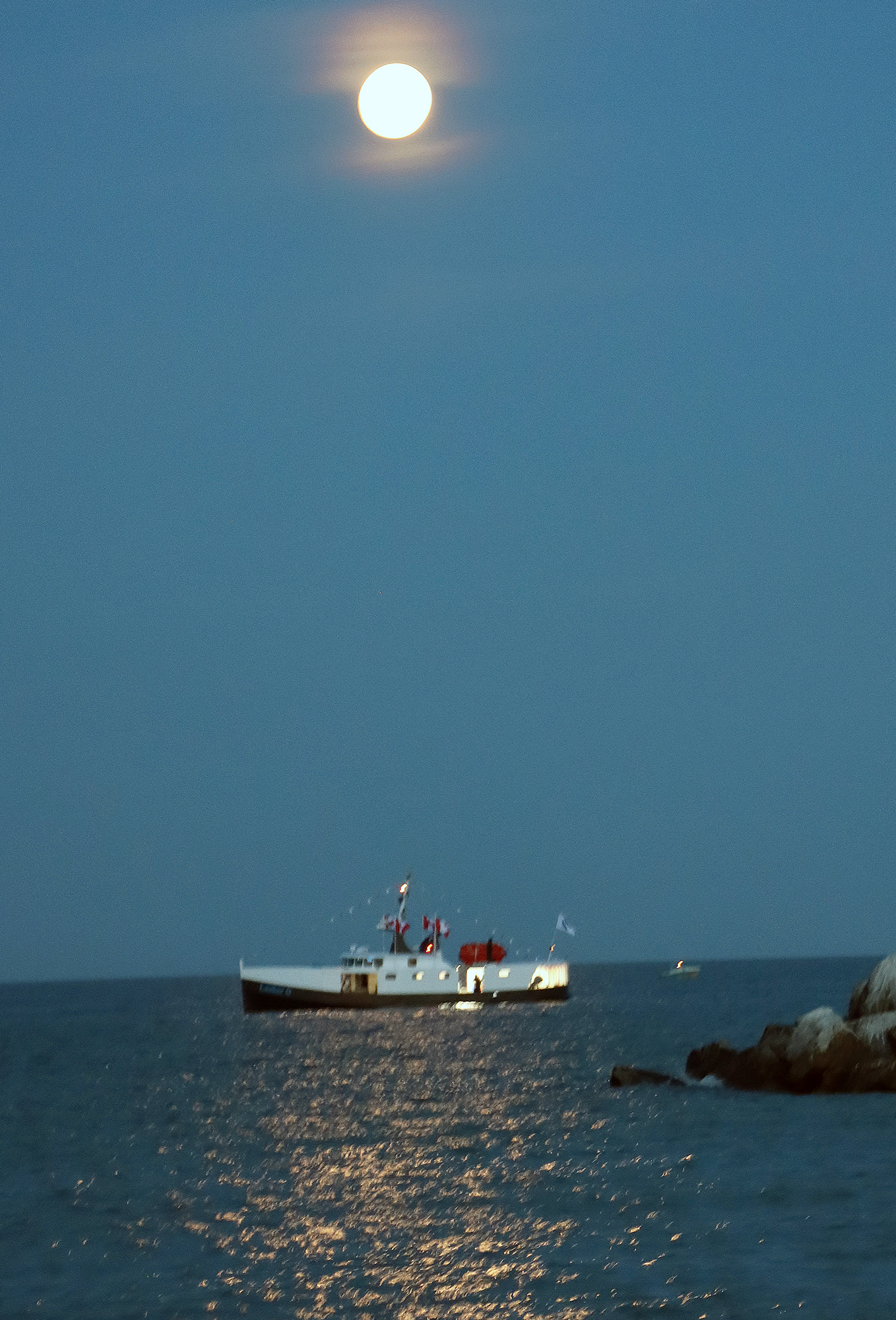 The Lasher O sits outside Wheatley Harbour under a full moon before the Wheatley Fish Festival fireworks.