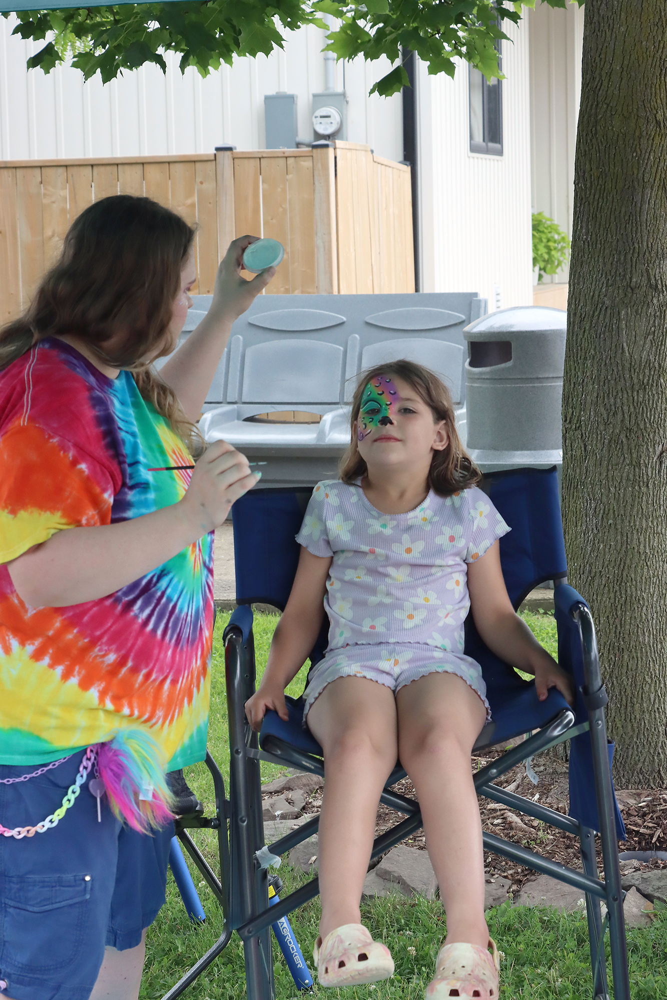 Everly Howe has her face painted like a colourful cheetah during the children's activities at the Wheatley Fish Festival.