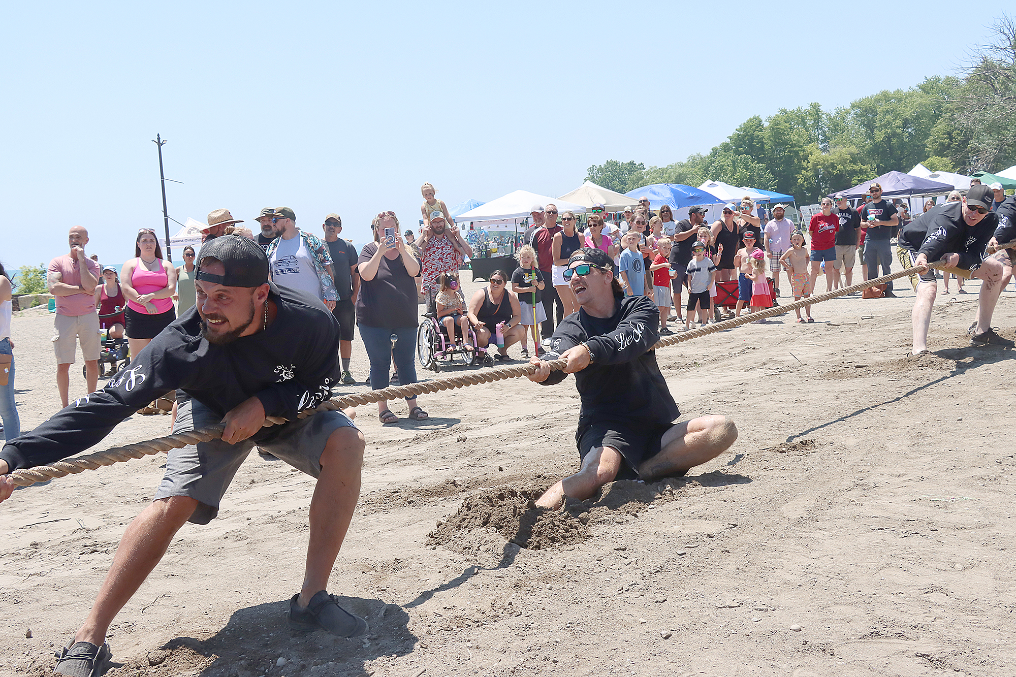 The Collard Fisheries tug of war team pulls against Garage Gym during the Wheatley Fish Festival.
