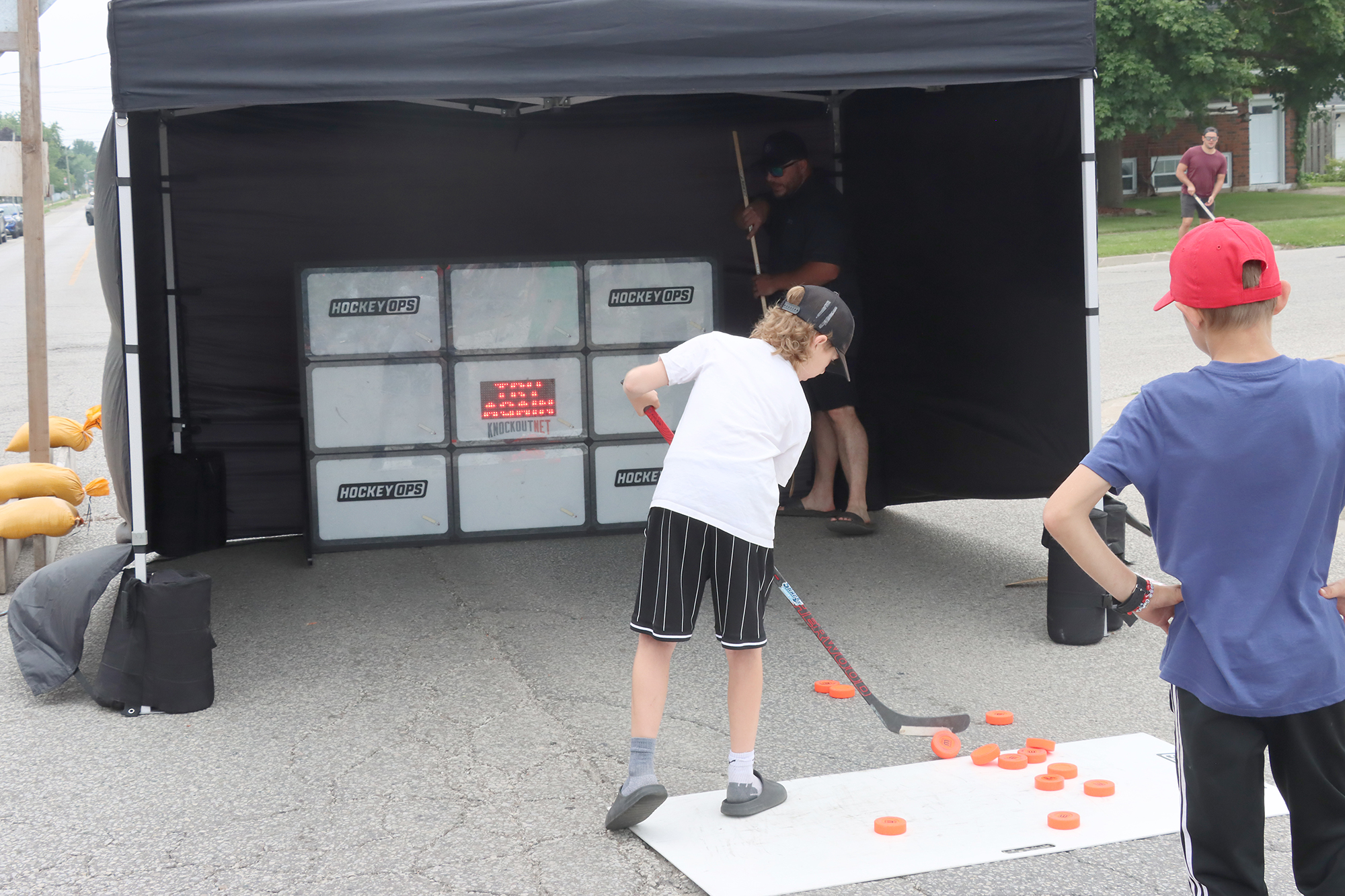 A young participant takes part in a hockey skills challenge during the Wheatley Fish Festival.