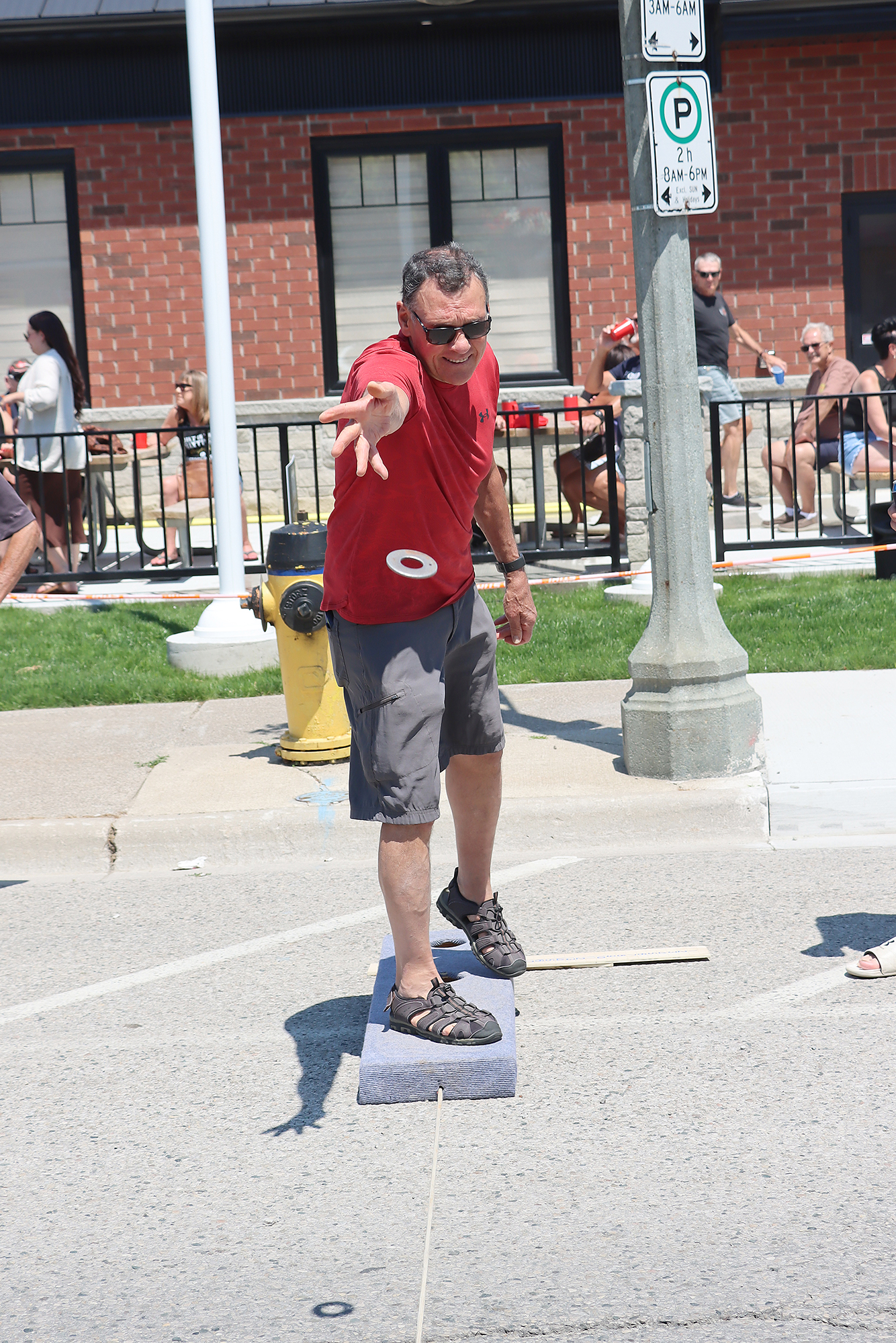 Scott Makey throws a steel washer during the waddies tournament at the Wheatley Fish Festival.