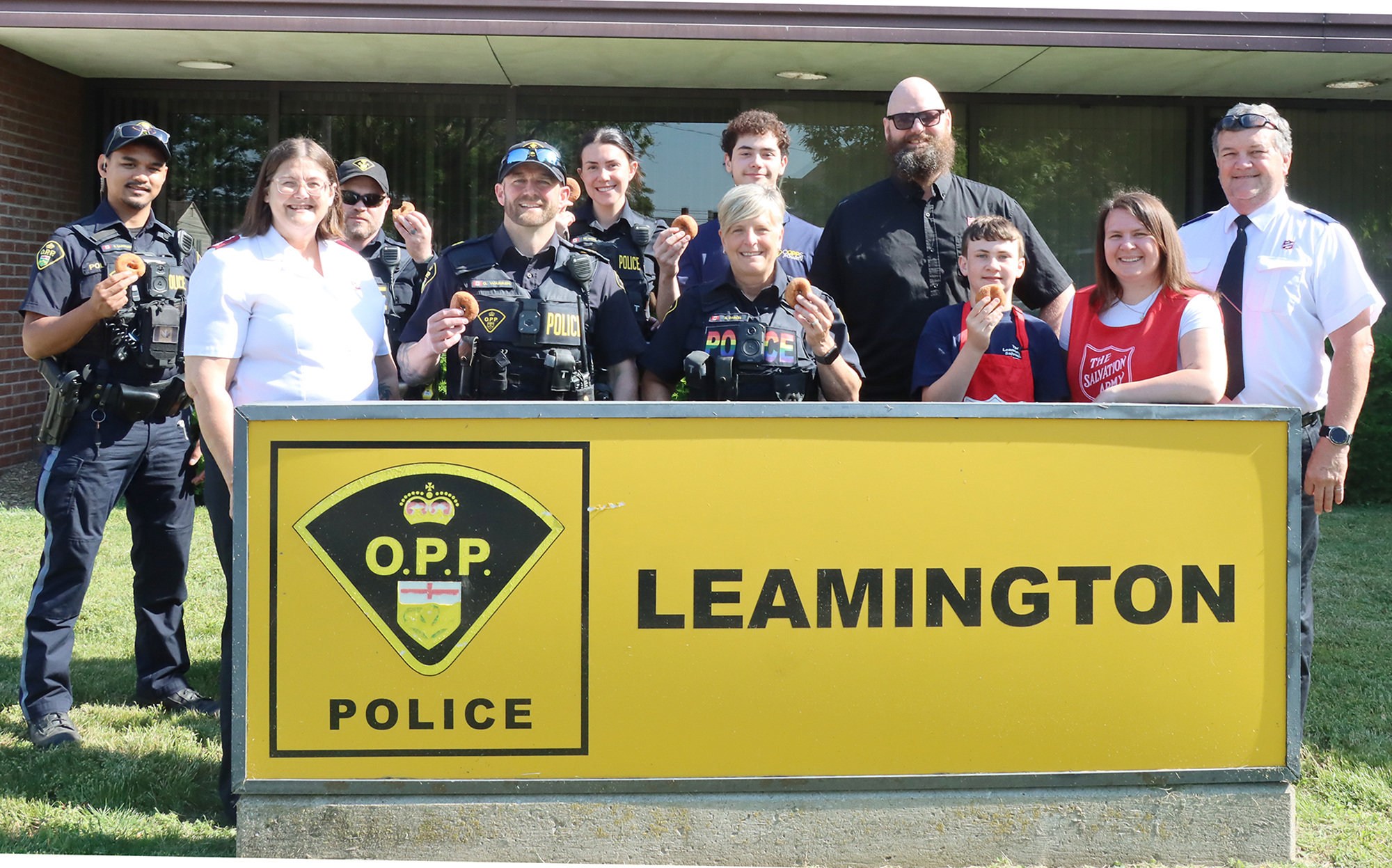 Salvation Army representatives and OPP officers pose outside the Leamington OPP detachment during a National Donut Day visit honoring local first responders.