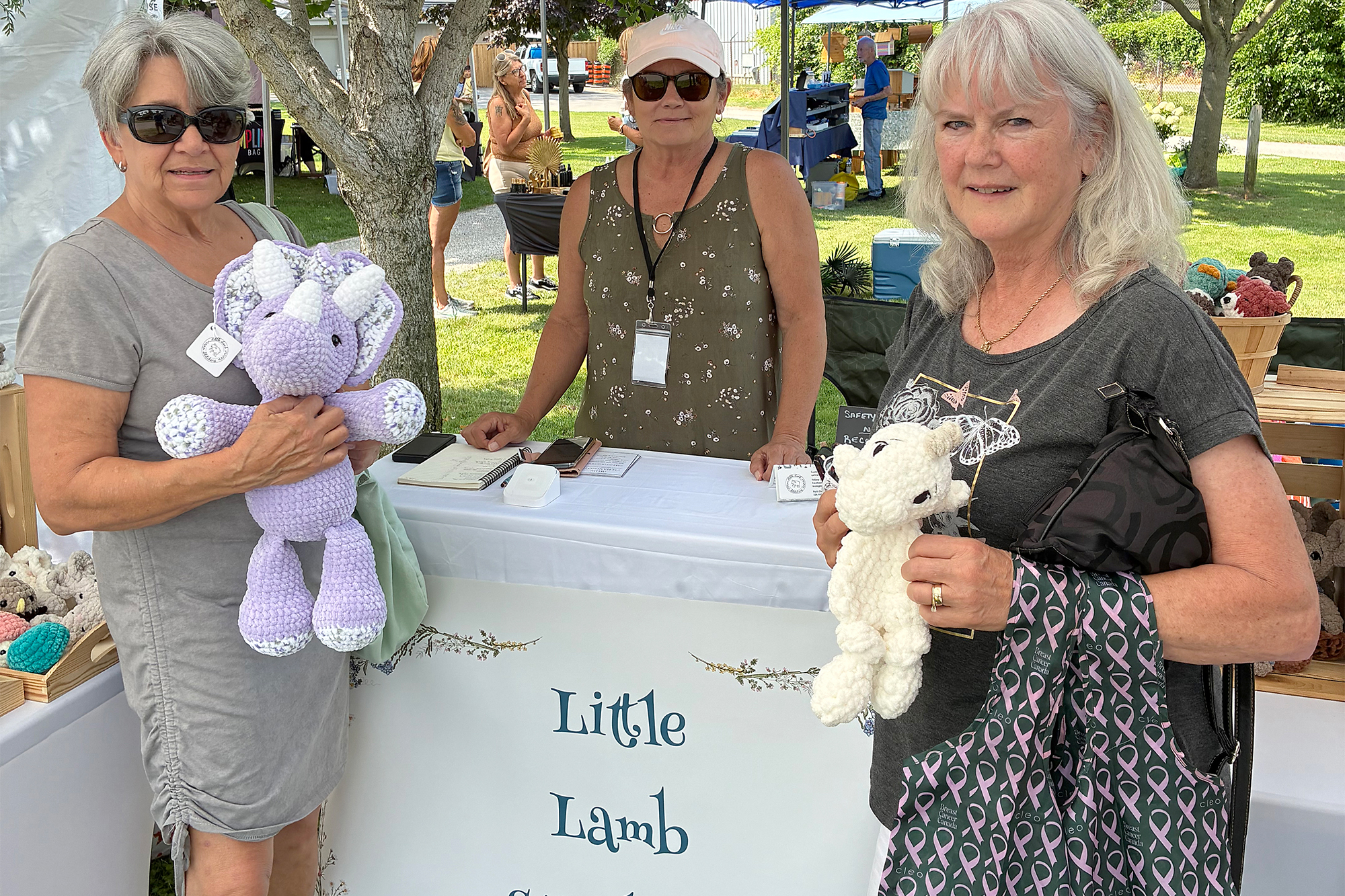 Little Lamb Stitchery owner Patti Dame with Colleen Pare and Pam Goyeau displaying handmade crochet creations at Arts at the Marina 2026.