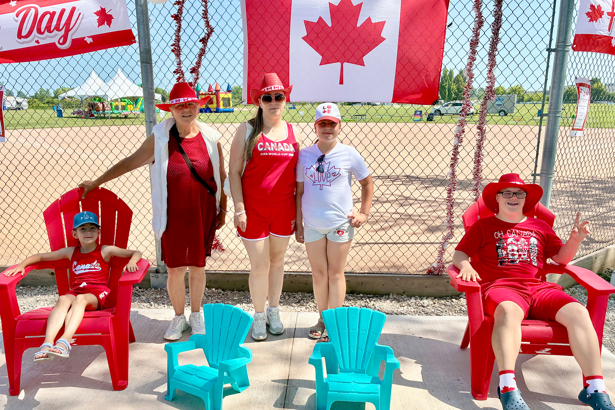 A group of children dressed in red and white Canada Day outfits pose for a photo during the Canada Day celebrations in Kingsville before enjoying the family activities.