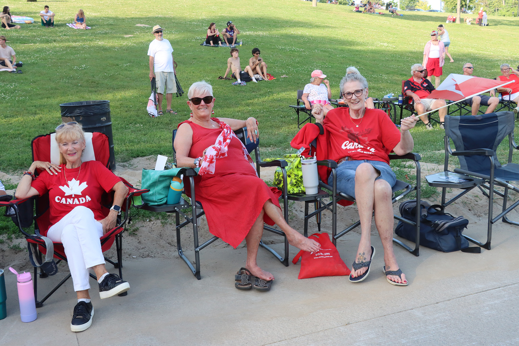 Suzi Clatworthy, Diane Shpaiuk and Terry Johnston sit together at Seacliff Park in Leamington ahead of the Canada Day music and fireworks.
