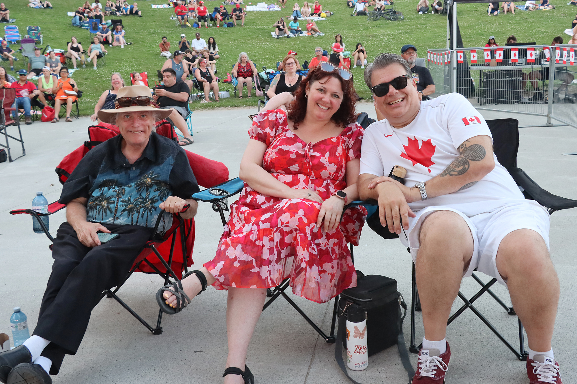 John Barnett, Becky Glover and Corey Robertson enjoy the Big Shiny Toons concert at the Sunset Amphitheatre during Leamington's Canada Day celebration.