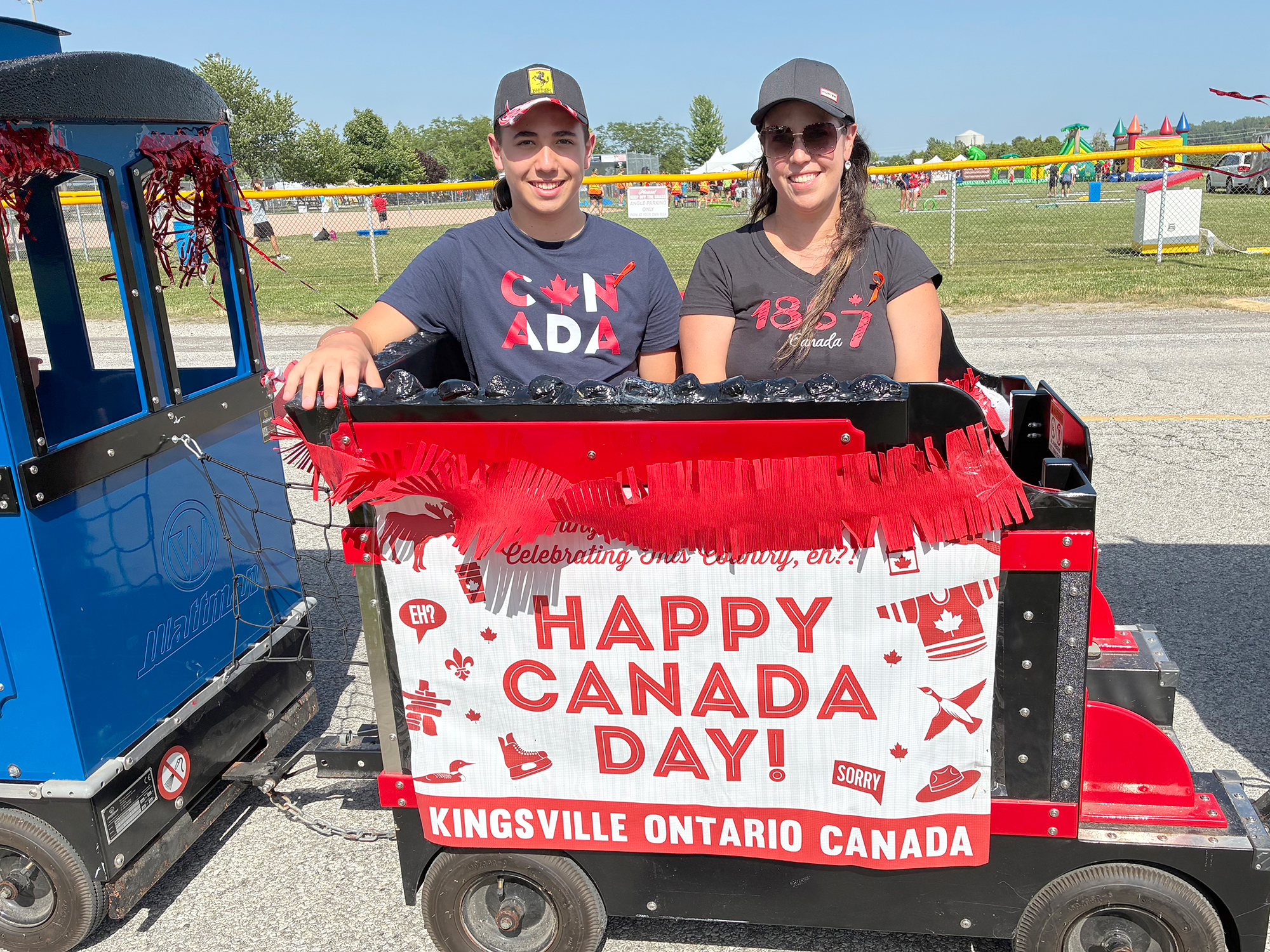 Mateo and Lisa ride the Canada Day Express train down Jasperson Lane during the Canada Day celebration in Kingsville.