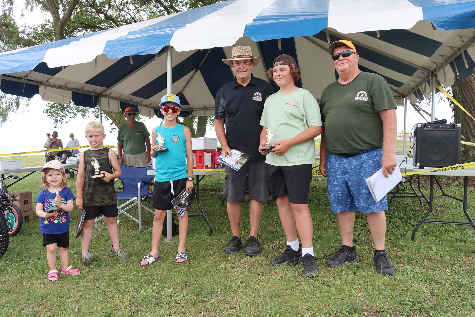 Winners of the Southwest Outdoors Club Kids Fishing Derby pose with their trophies alongside SWOC President Dan Reive and SWOC member Pete Lein at Wheatley Harbour.