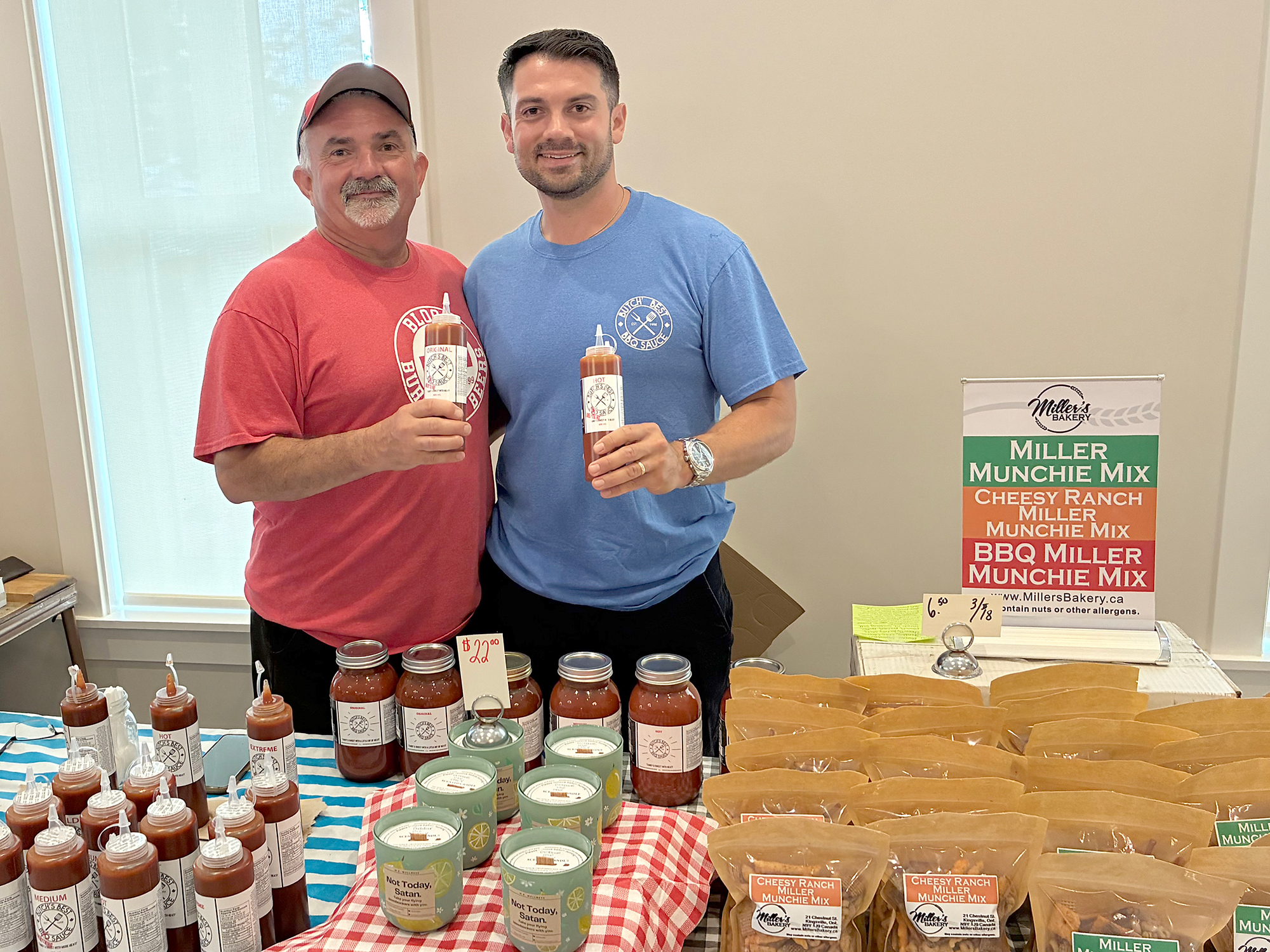 Ted Rocheleau and his son T.J. showcase Butch's Best BBQ Sauce with Miller's Bakery in the vendors' alley at the Kingsville Block Party.