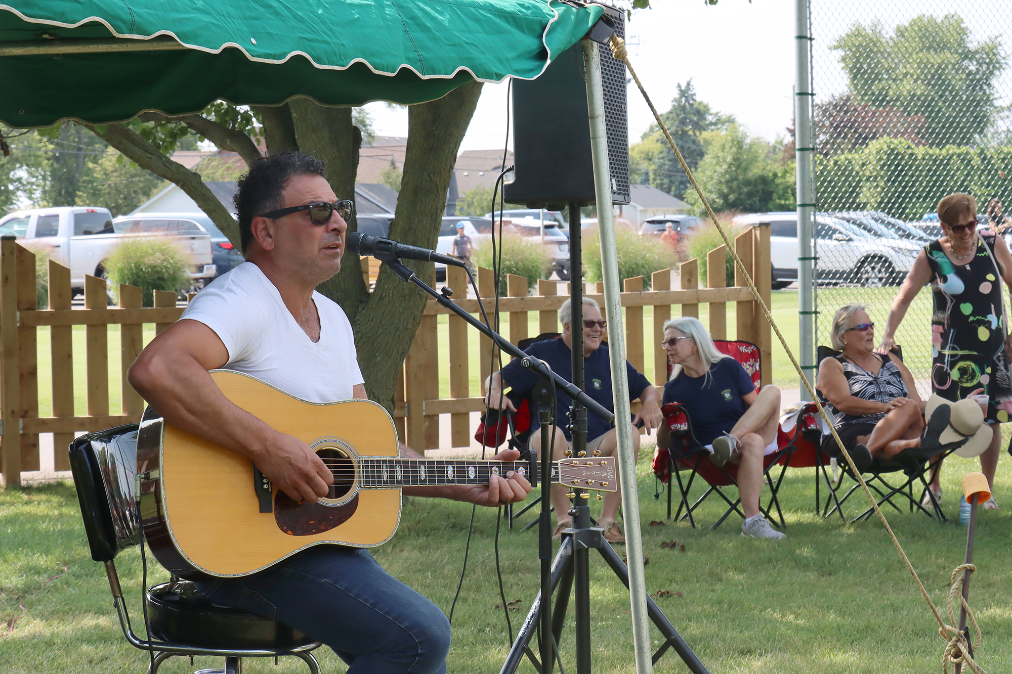 Jody Raffoul performs an acoustic set on the first fairway during the Erie Shores centennial celebration.