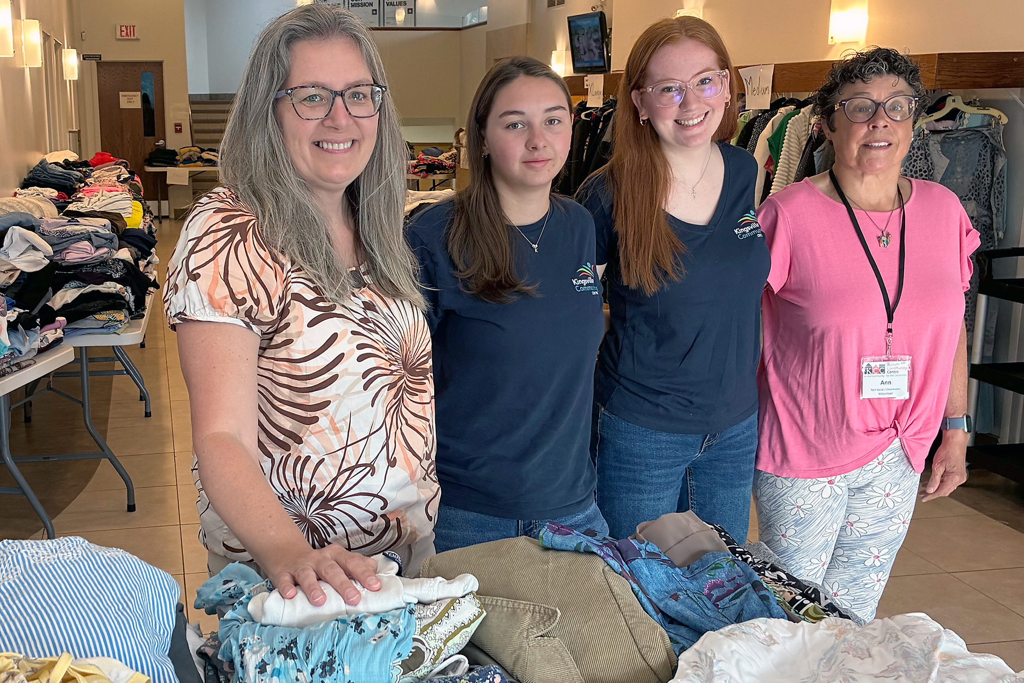 KCC Executive Director Kim DeYong, summer staff Kyla Durocher and Lauren DeYong, and volunteer Ann Kirst make final preparations before the Ladies’ Clothing Swap at the Kingsville Community Centre.