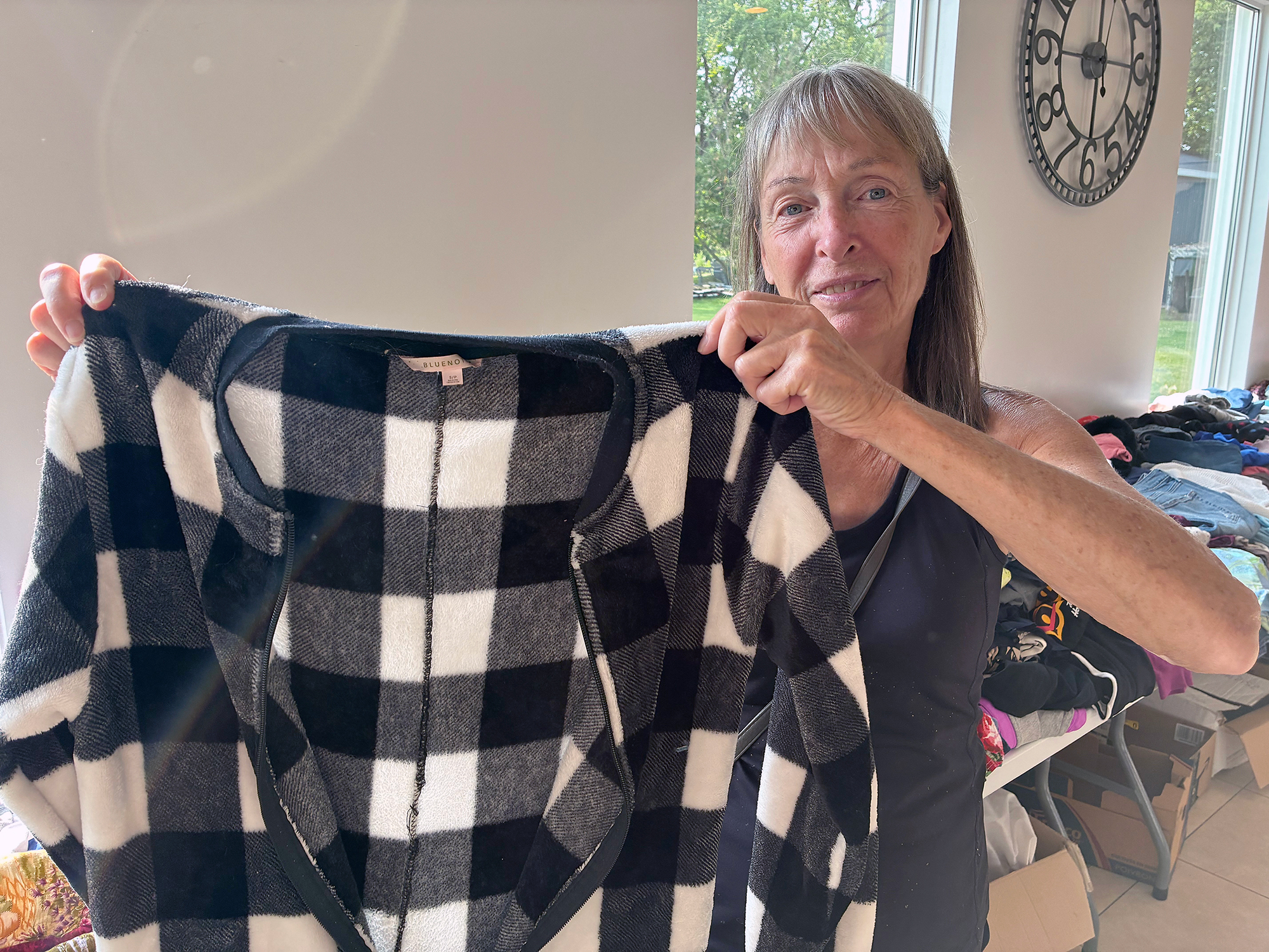 Beth Reitsma of Cottam browses donated clothing during the Ladies’ Clothing Swap at the Kingsville Community Centre in search of a sweater or two.