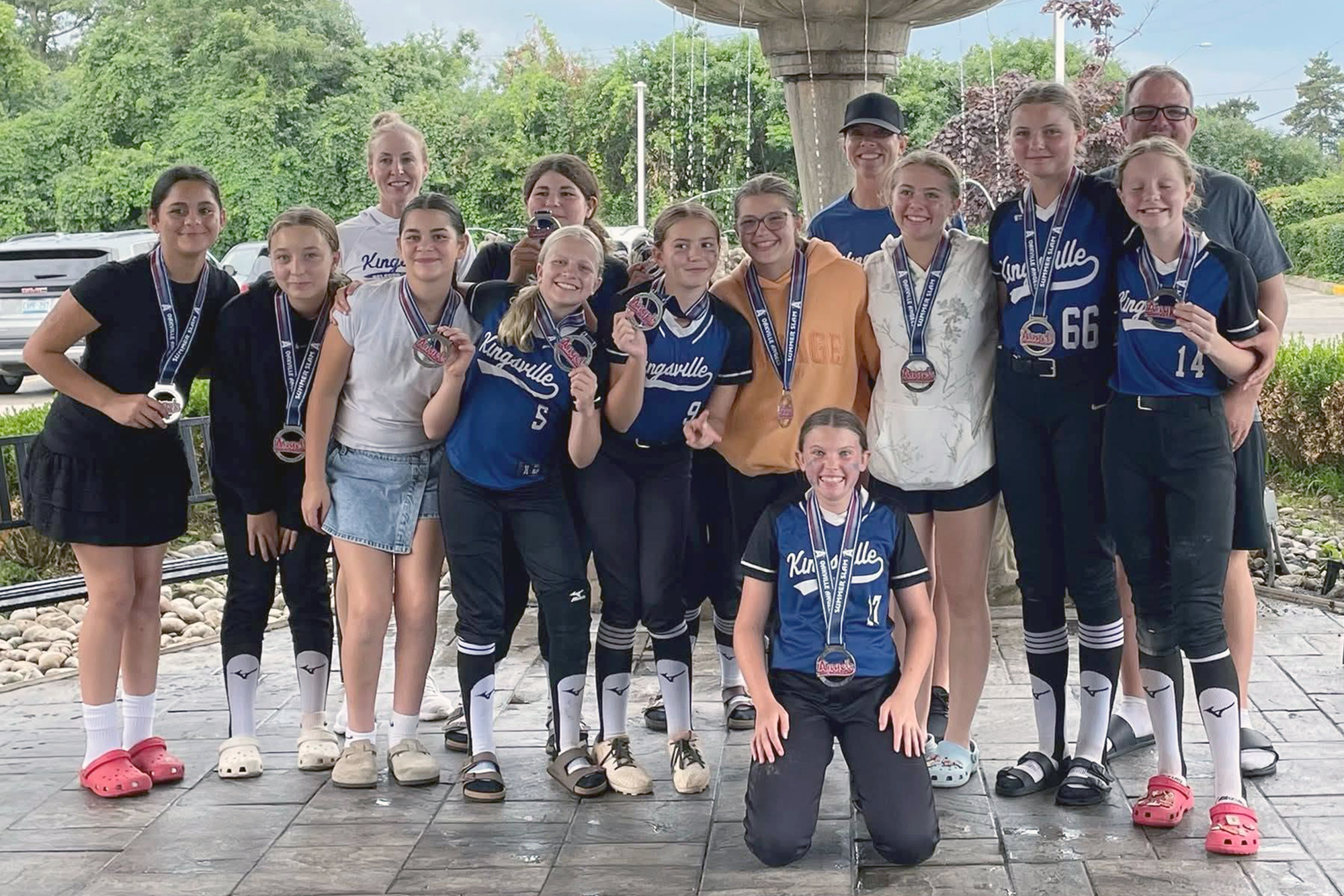 U13 Kingsville Knights Girls Fastpitch Team players and coaches pose together for a team photo.