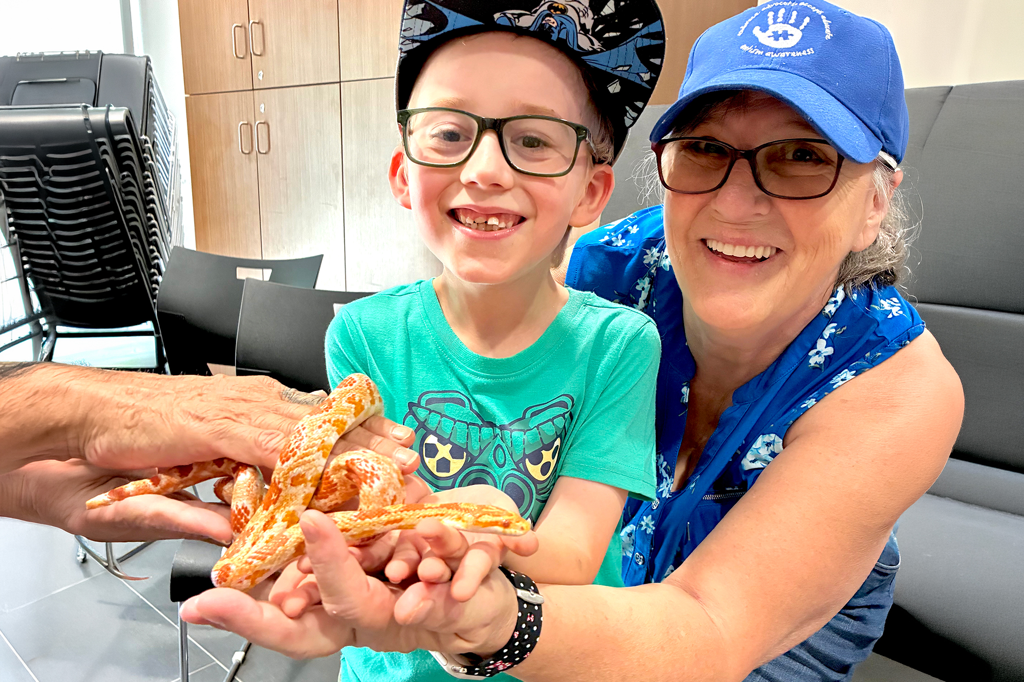 Eight-year-old Emmitt Frame holds a corn snake with his grandmother Jackie Maybee at the Point Pelee National Park Visitor Centre.