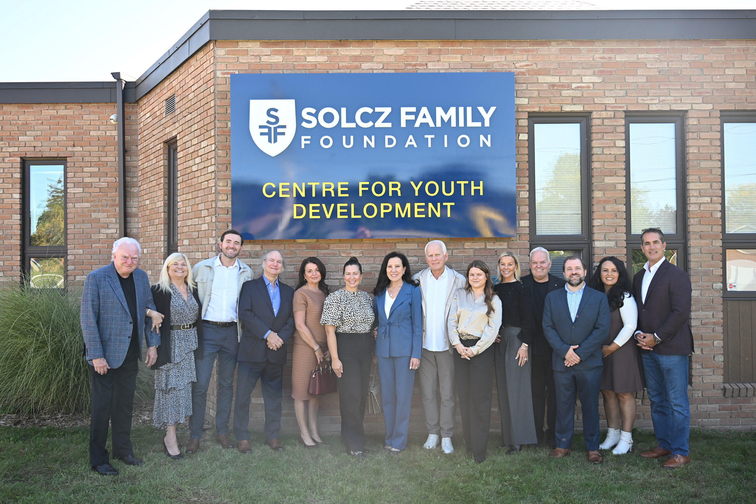 Members of the Solcz family meet with members of The Bridge Youth Resource Centre for the announcement.