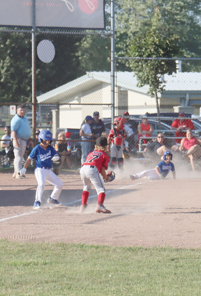 Kingsville Knights player Jack Bryant scores while teammate Nico Olsen reaches first base during their game against the Georgina Bulldogs. Kingsville won the game 21-13.