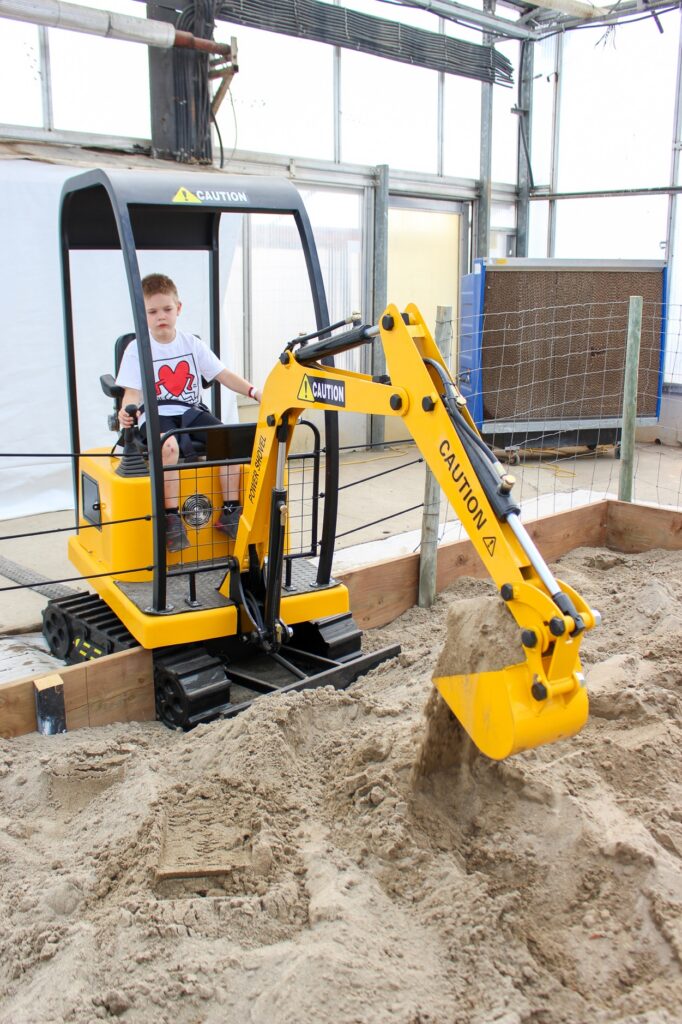 Emerson Ross, 6, tries out the controls of Thiessen’s newest attraction, the Little Diggers.
