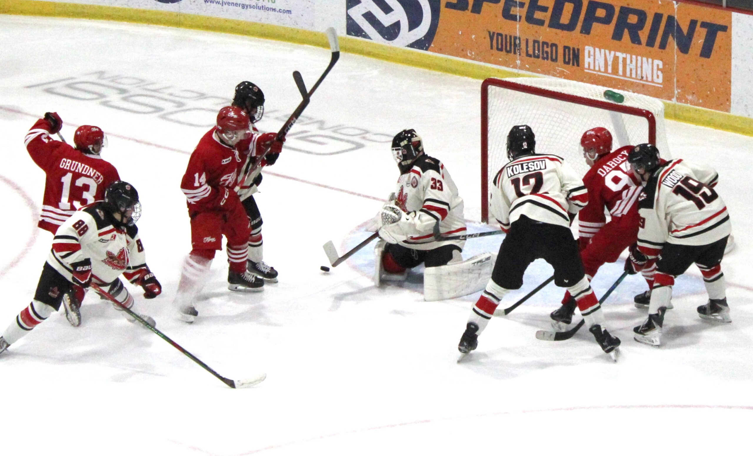 Josh Cleary (14) watches Griffin Grundner’s shot as Niagara goalie Timofey Williams is about to make a second period save, while Ashton Darocy (97) awaits a rebound to the right of the net during Sunday night’s 5-1 win. Scott Holland photo