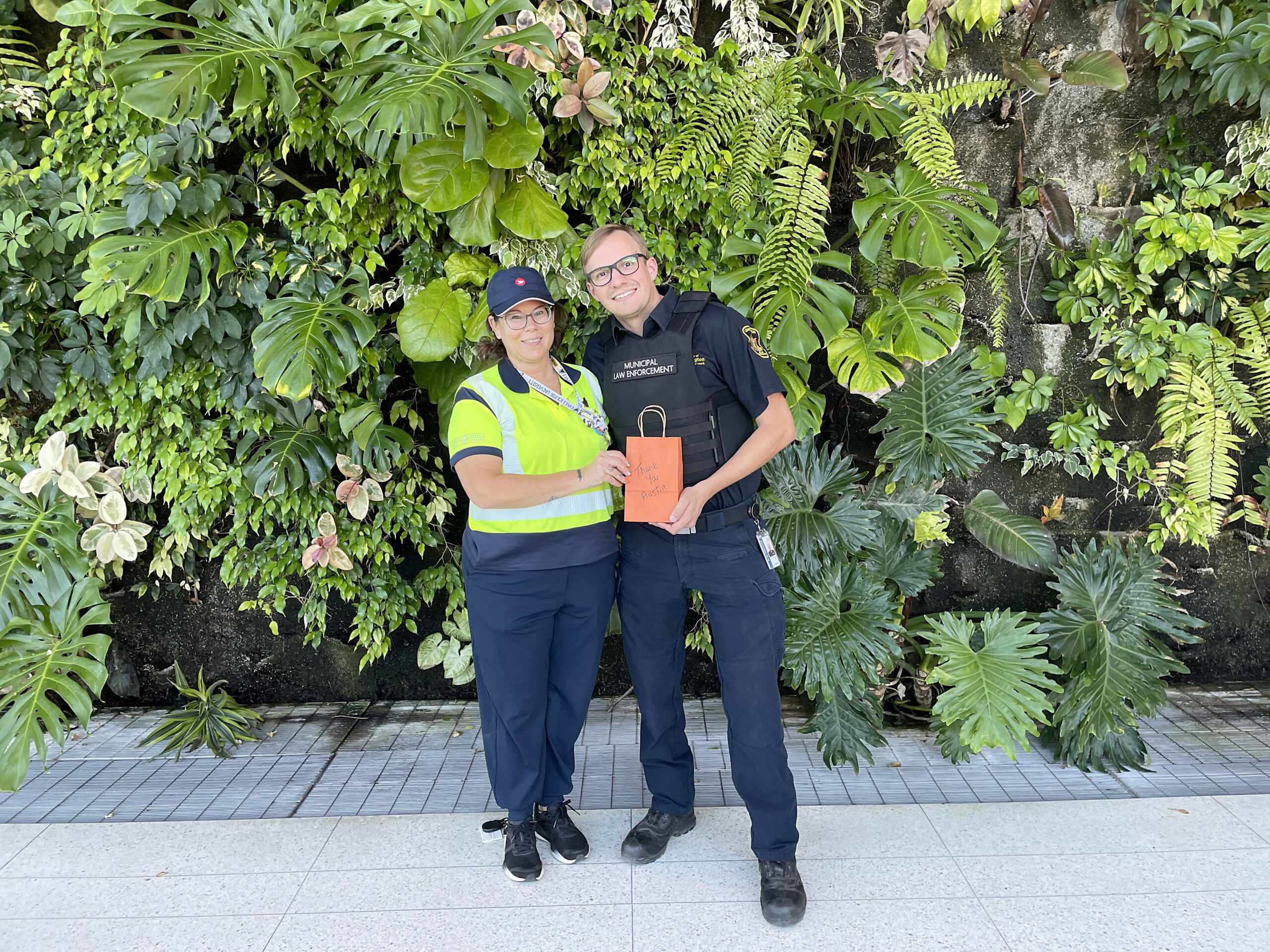 Canada Post employee Niki Demmans presents a thank you gift to By-Law Enforcement Officer Austin Aldridge at the town hall recently. Aldridge’s CPR on mail carrier John Ridley saved Ridley’s life.