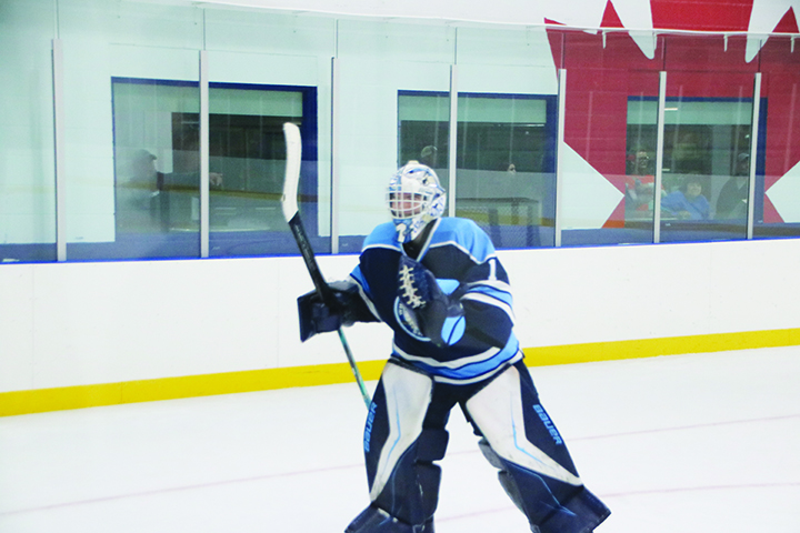 Sharks goaltender Adam Flanagan celebrates as the last player to leave the ice after backstopping his teammates with a 33 save performance and a thrilling comeback from behind overtime victory over previously unbeaten Lakeshore Canadians.